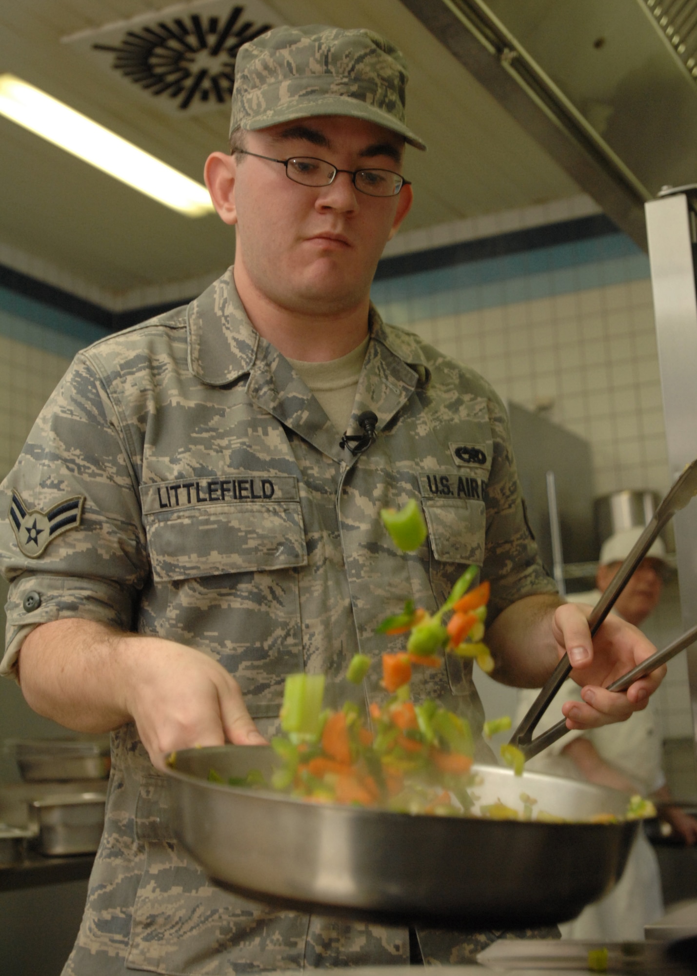 SPANGDAHLEM AIR BASE, Germany -- Airman 1st Class James Littlefield, 52nd Aircraft Maintenance Squadron Team Stinger, sautés a vegetable medley March 30, 2009 during the Iron Chef competition at the Mosel Dining Facility. Two teams of four competed for the coveted title of Iron Chef by creating three main dishes using a limited number of ingredients in three hours of cook time before being tasted by a panel of judges. (U.S. Air Force photo by Senior Airman Jenifer H. Calhoun)