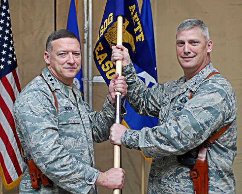 Lt. Gen. Gary North, 9th Air Force and U.S. Air Forces Central commander, hands the 504th Expeditionary Air Support Operations Group guidon to Col. James Thomas as he assumes command of the unit at Bagram Air Field, Afghanistan, March 30. The colonel is the first commander of the group that leads more than 125 air liaison officers, tactical air controls and combat weather Airmen assigned to the 717th Air Support Operations Squadron, 817th ASOS and 917th Combat Weather Squadrons deployed throughout Afghanistan.
