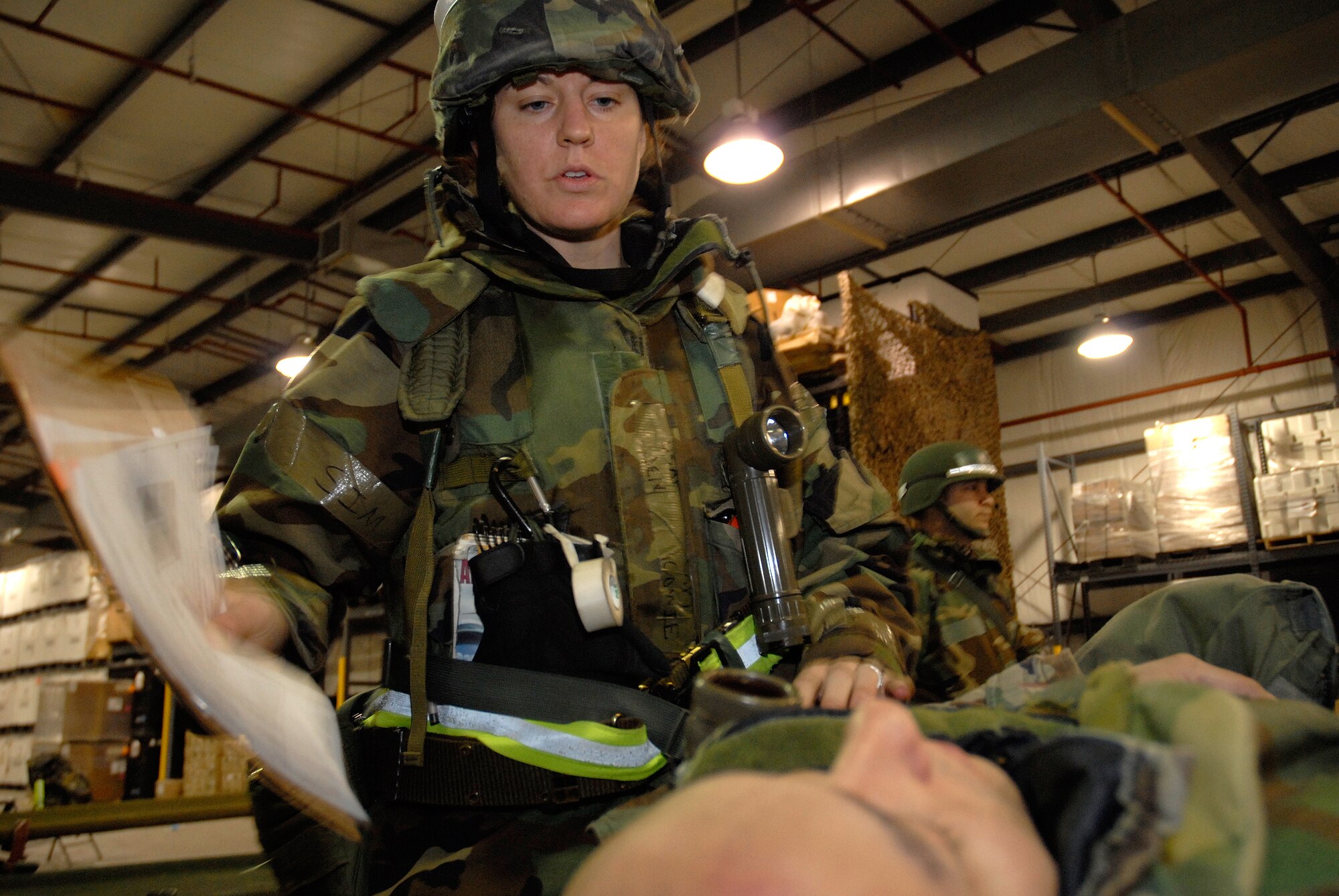 Capt. Jennifer Cowie, a nurse with the 8th Medical Operations Squadron, explains what medical procedures will be carried out to a roleplayer-patient at Kunsan Air Base, Republic of Korea, March 31, 2009. Kunsan Airmen are currently participating in the peninsula-wide Operational Readiness Exercise Beverly Bulldog 09-02 in preparation for an upcoming Operational Readiness Inspection. (U.S. Air Force Photo by Staff Sgt. Jason Colbert)