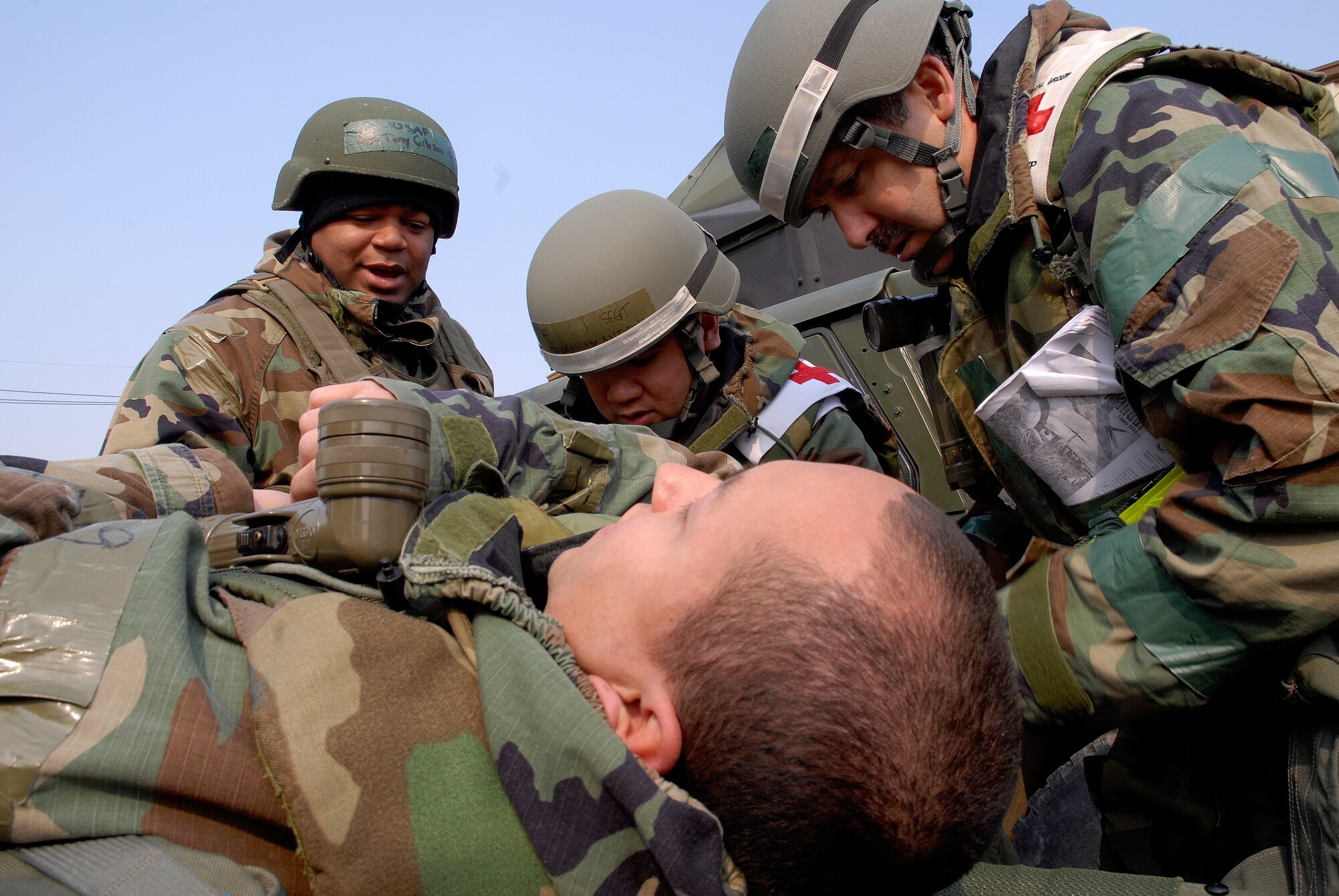 Airmen from the 8th Medical Group check for identification of a fellow Airman, playing the role of a casualty at Kunsan Air Base, Republic of Korea, March 31, 2009. Kunsan Airmen are currently participating in the peninsula-wide Operational Readiness Exercise Beverly Bulldog 09-02 in preparation for an upcoming Operational Readiness Inspection. (U.S. Air Force Photo by Staff Sgt. Jason Colbert)