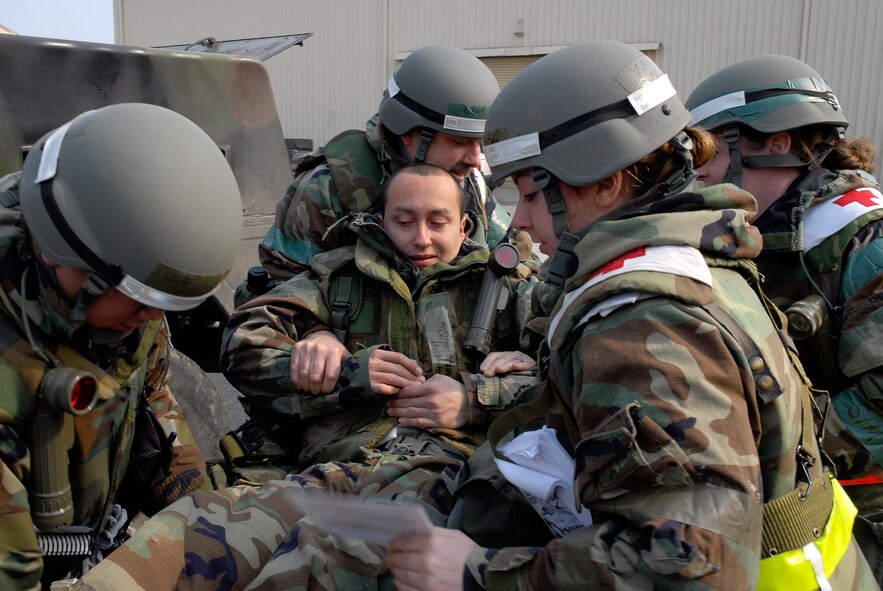 Airmen from the 8th Medical Group transfer a fellow Airman, playing the role of a casualty, onto a stretcher at Kunsan Air Base, Republic of Korea, March 31, 2009. Kunsan Airmen are currently participating in the peninsula-wide Operational Readiness Exercise Beverly Bulldog 09-02 in preparation for an upcoming Operational Readiness Inspection. (U.S. Air Force Photo by Staff Sgt. Jason Colbert)