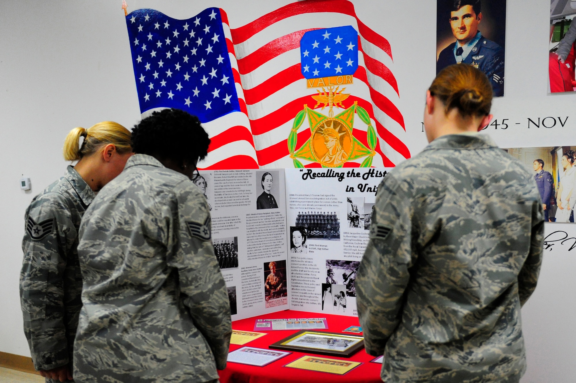 Posters of females in the U.S. military were placed throughout the room during the 380 Air Expeditionary Wing Women's History Month symposium luncheon. The theme, "Recalling Women in Uniform" highlighted the contributions of female Airmen and Soldiers both past and present. (U.S. Air Force Photo by Capt. Jennifer Pearson) (Released)
