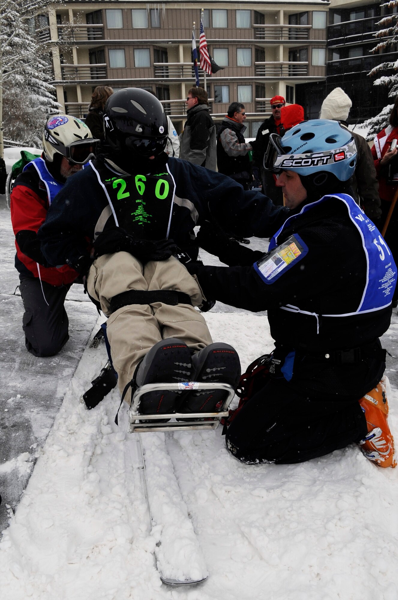 Senior Airman Shawn O'Neil waits his turn to mono-ski with the help of an instructor during the 23rd National Disabled Veterans Winter Sports Clinic held March 30 at the Snowmass Village, Colo. The annual disabled learn-to-ski clinic helps motivate and rehabilitate disabled Department of Defense veterans. (U.S. Air Force photo/Staff Sgt. 
Desiree N. Palacios)

