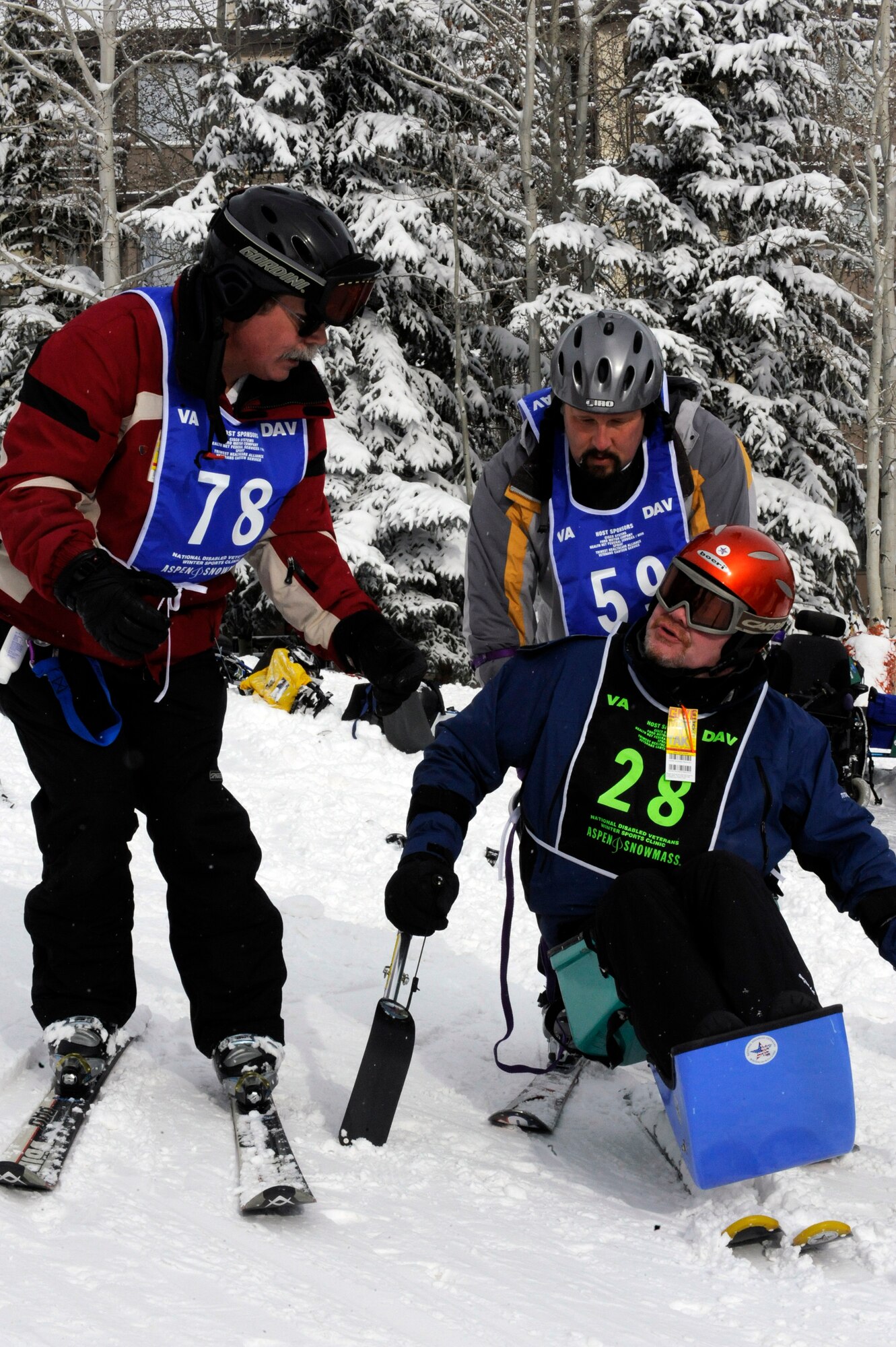 Glenn Hallberg and Mark Finken teach Michael Murphy how to ski March 30 during the 23rd National Disabled American Veterans Winter Sports Clinic. Mr. Hallberg and Mr. Finken are ski instructors for the sports clinic. Mr. Murphy is prior Air Force and his hometown is Dayton, Ohio.  This is Mr. Murphy's first year attending the Disabled American Veteranss Winter Sports Clinic. (U.S. Air Force photo/Staff Sgt. Desiree N. Palacios)