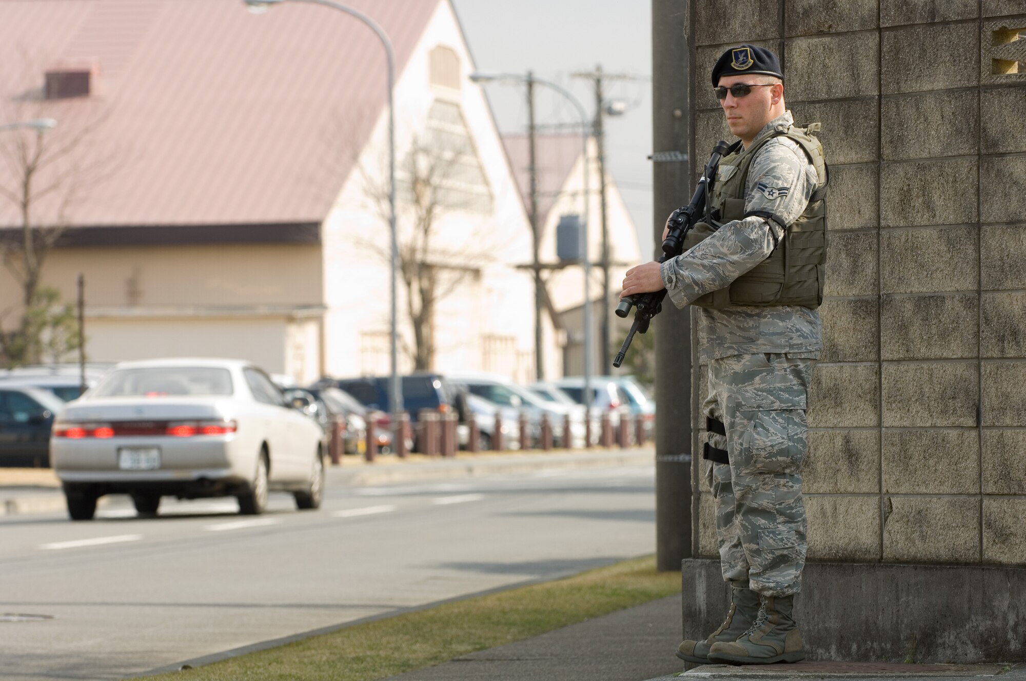 YOKOTA AIR BASE, Japan -- Airman 1st Class Anthony Garcia, 374th Security Forces Squadron, patrols Davis street in search for a simulated gate runner March 31 during Phase I of Exercise Beverly Morning 09-03. Yokota is conducting an exercise March 30 through April 3 to maintain operational readiness.  (U.S. Air Force photo/Osakabe Yasuo)