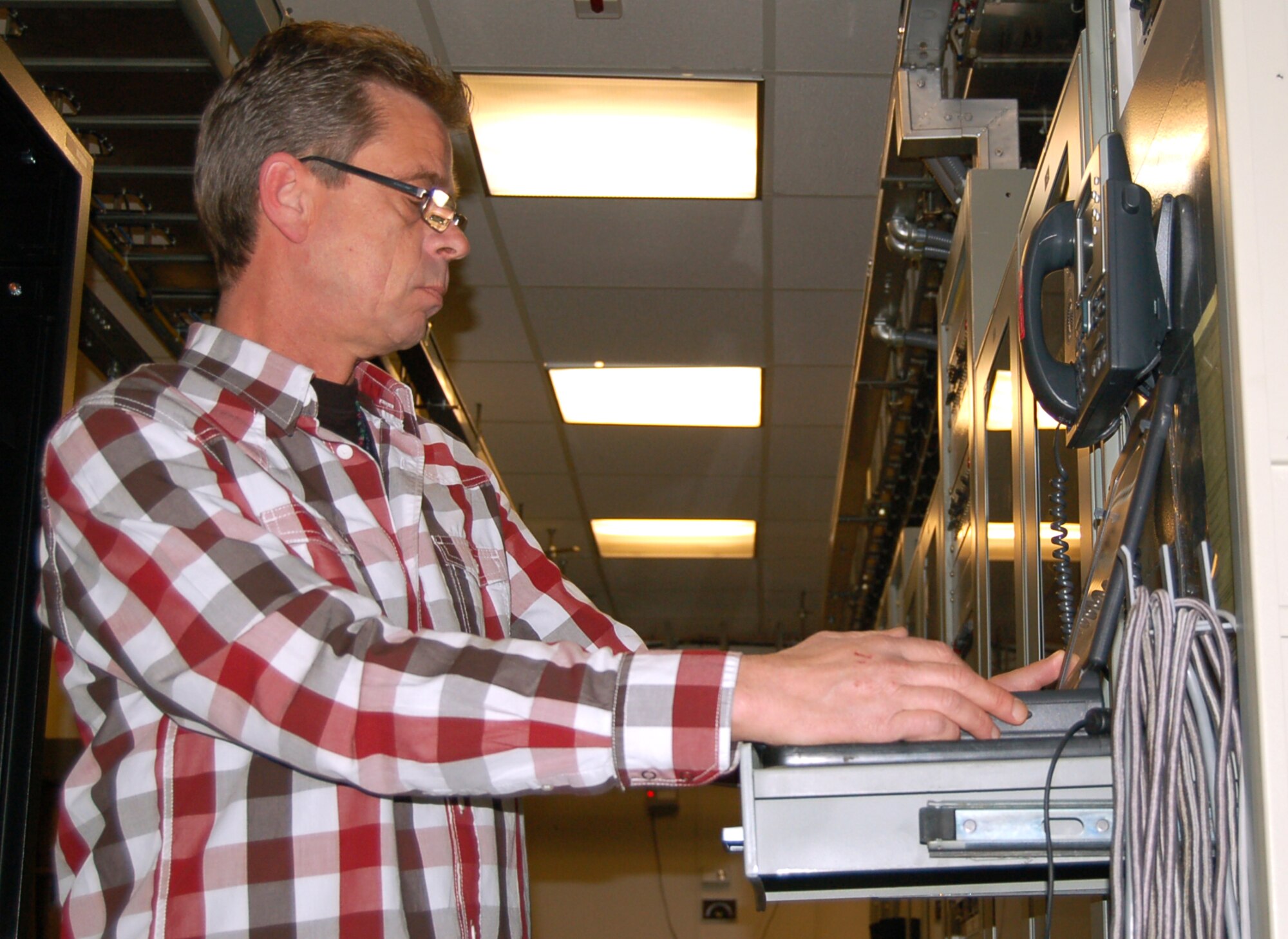 SPANGDAHLEM AIR BASE, Germany – Thad Baldridge, ITT Industries contractor working for the 52nd Communications Squadron, monitors telecommunications equipment in the Spangdahlem Global Information Grid office March 30, 2009. The office was recently named the European Defense Information Systems Network Outstanding GIG Facility of the Year. Same-sized offices across Europe within the Air Force, Army and Navy compete for this award. This office has placed no lower than runner-up in the Europe DISA annual awards since 2001. (U.S. Air Force photo by Staff Sgt. Tammie Moore)