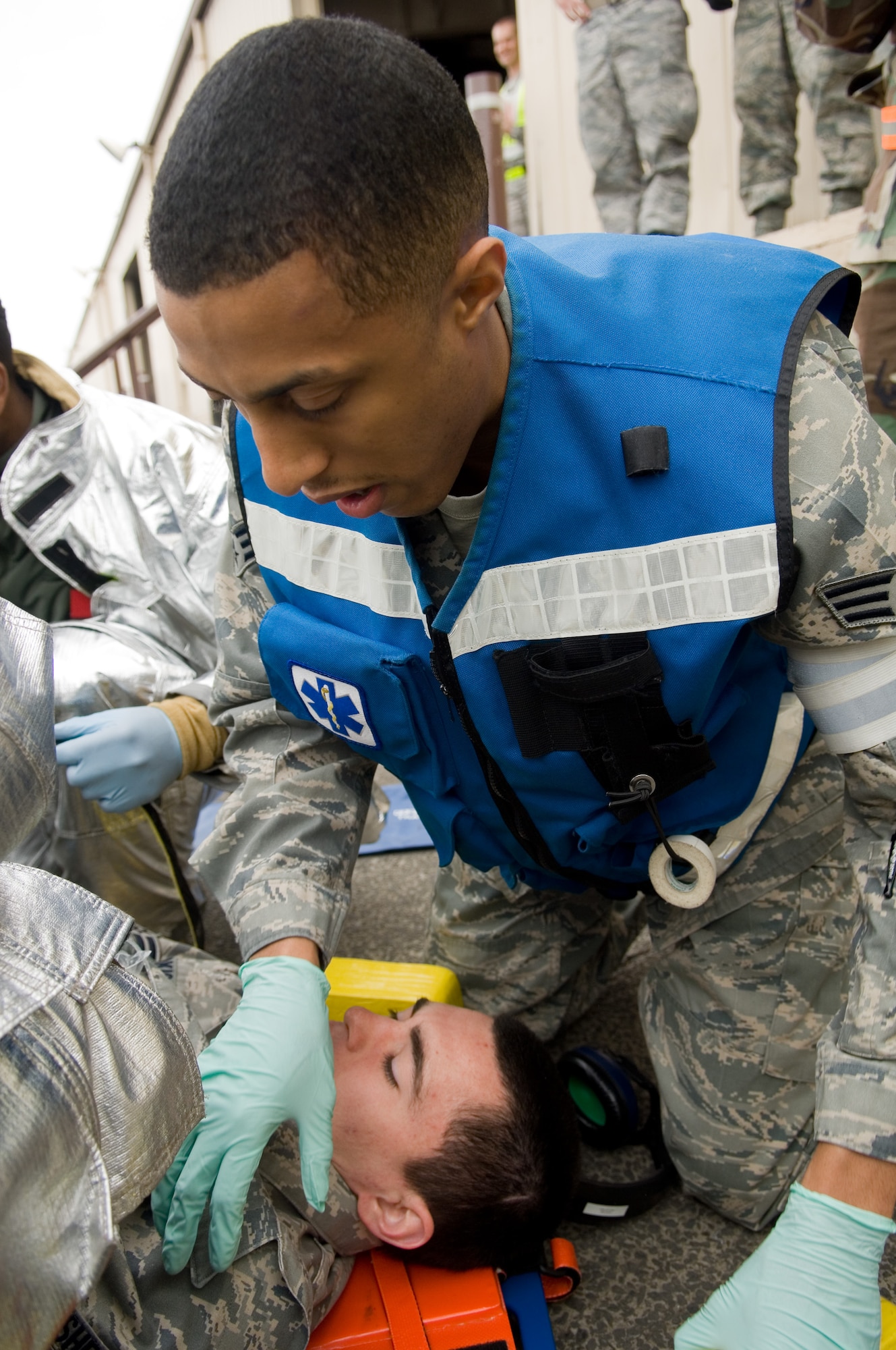 YOKOTA AIR BASE, Japan -- Senior Airman Rafael Gutierrez, 374th Medical Operations Squadron, performs immobilization procedure on a simulated suspected spinal injured patient  March 31 during Phase I of Exercise Beverly Morning 09-03. Yokota is conducting an exercise March 30 through April 3 to maintain operational readiness. (U.S. Air Force photo/Osakabe Yasuo)