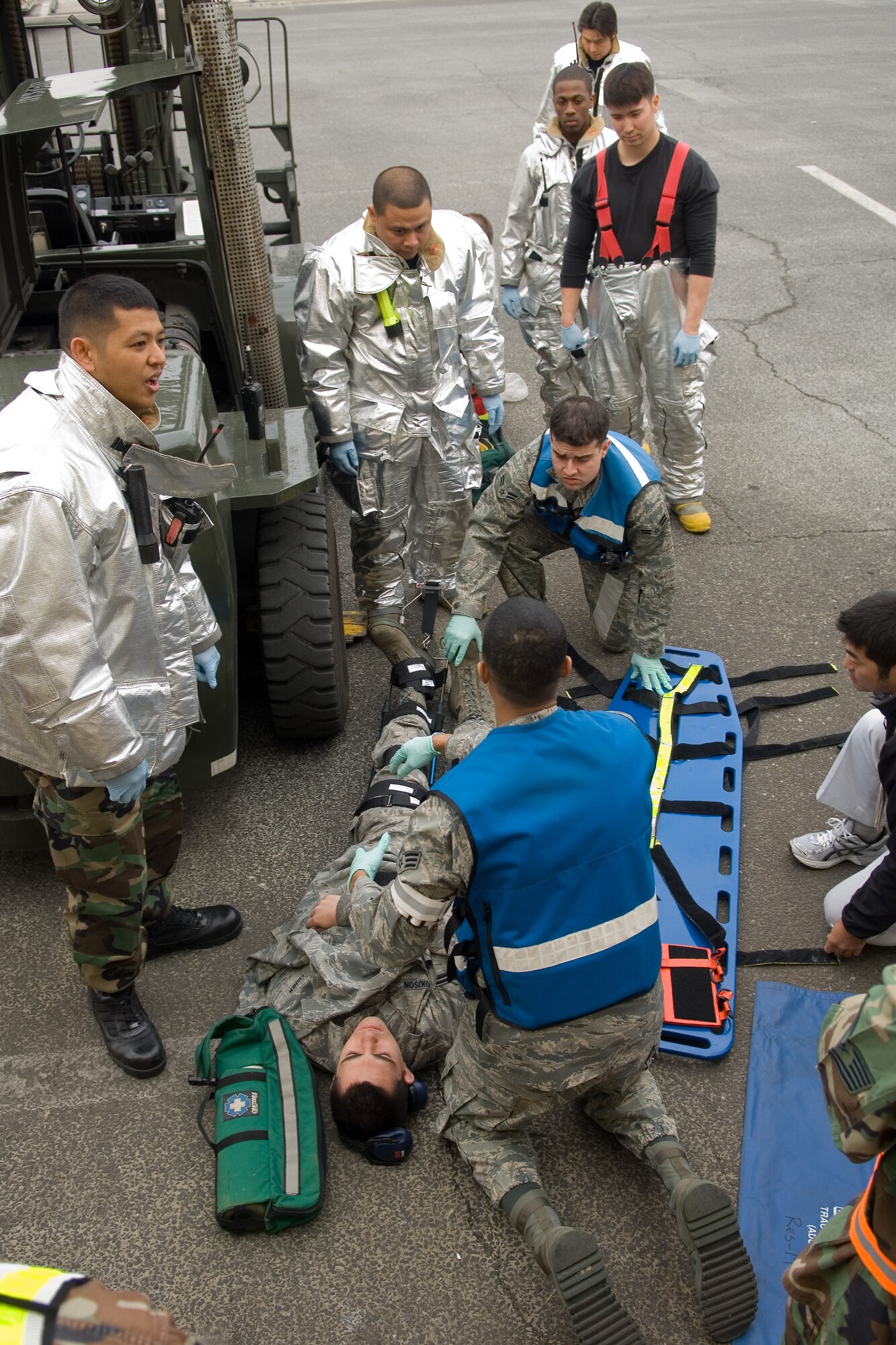 YOKOTA AIR BASE, Japan -- Yokota Fire Department and Emergency Response Personnel respond to a simulated 10K forklift accident site March 31 during Phase I of Exercise Beverly Morning 09-03. Yokota is conducting an exercise March 30 through April 3 to maintain operational readiness.(U.S. Air Force photo/Osakabe Yasuo)