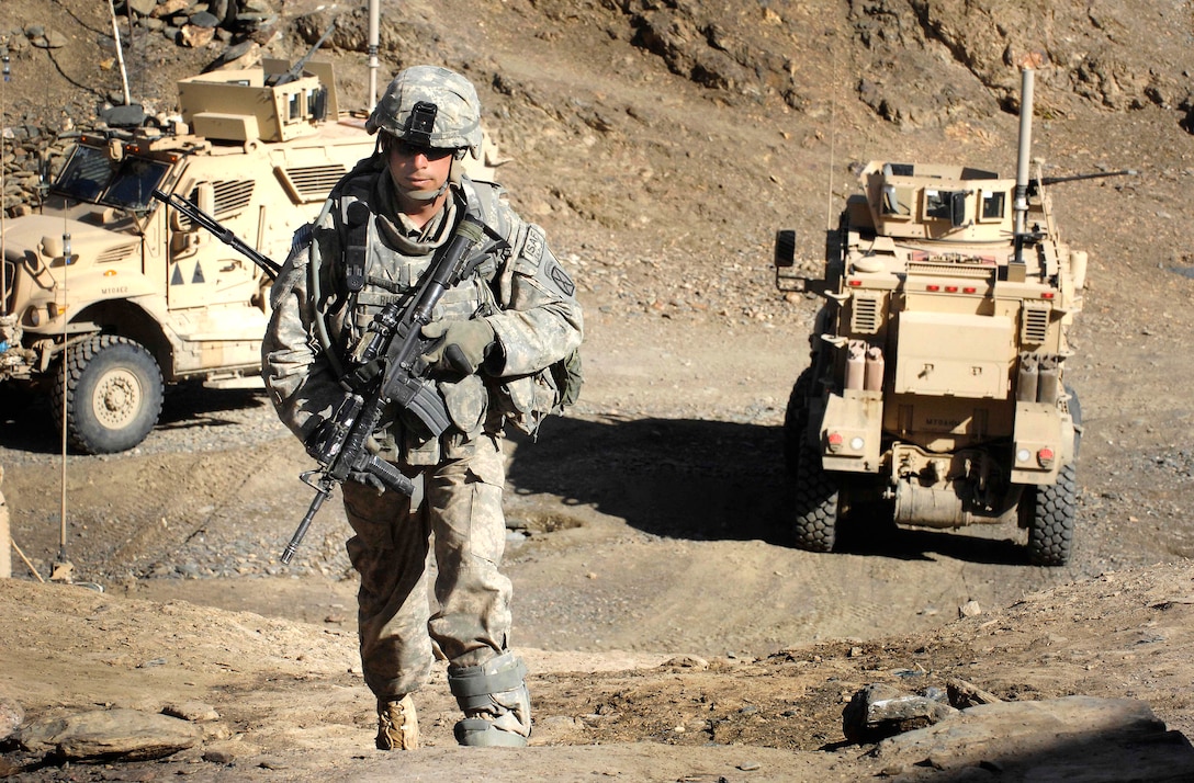 U.S. Army Staff Sgt. Robert Rios walks into a village in Jalrez Valley ...