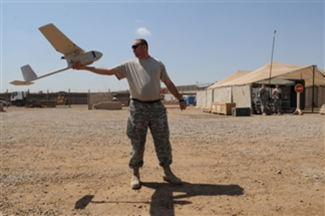 U.S. Army Sgt. 1st Class Wayne Davidson of Brigade Special Troops Battalion, 3rd Brigade Combat Team, 82nd Airborne Division prepares to launch the Raven unmanned aerial vehicle system at Joint Security Station Loyalty, eastern Baghdad, Iraq, on March 25, 2009.  