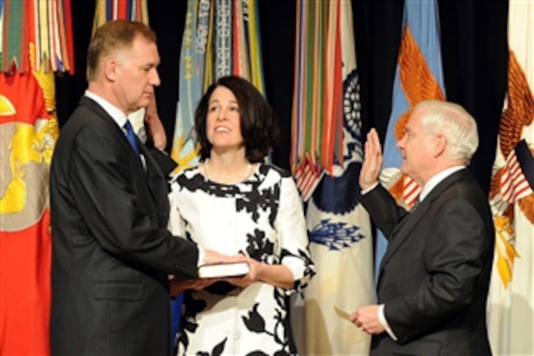 Secretary of Defense Robert M. Gates (right) administers the oath of office to Deputy Secretary of Defense William Lynn III as Lynnís wife Mary Murphy holds the Bible during a welcoming ceremony for Lynn in the Pentagon on March 30, 2009.  Lynn is the 30th Deputy Secretary of Defense.  