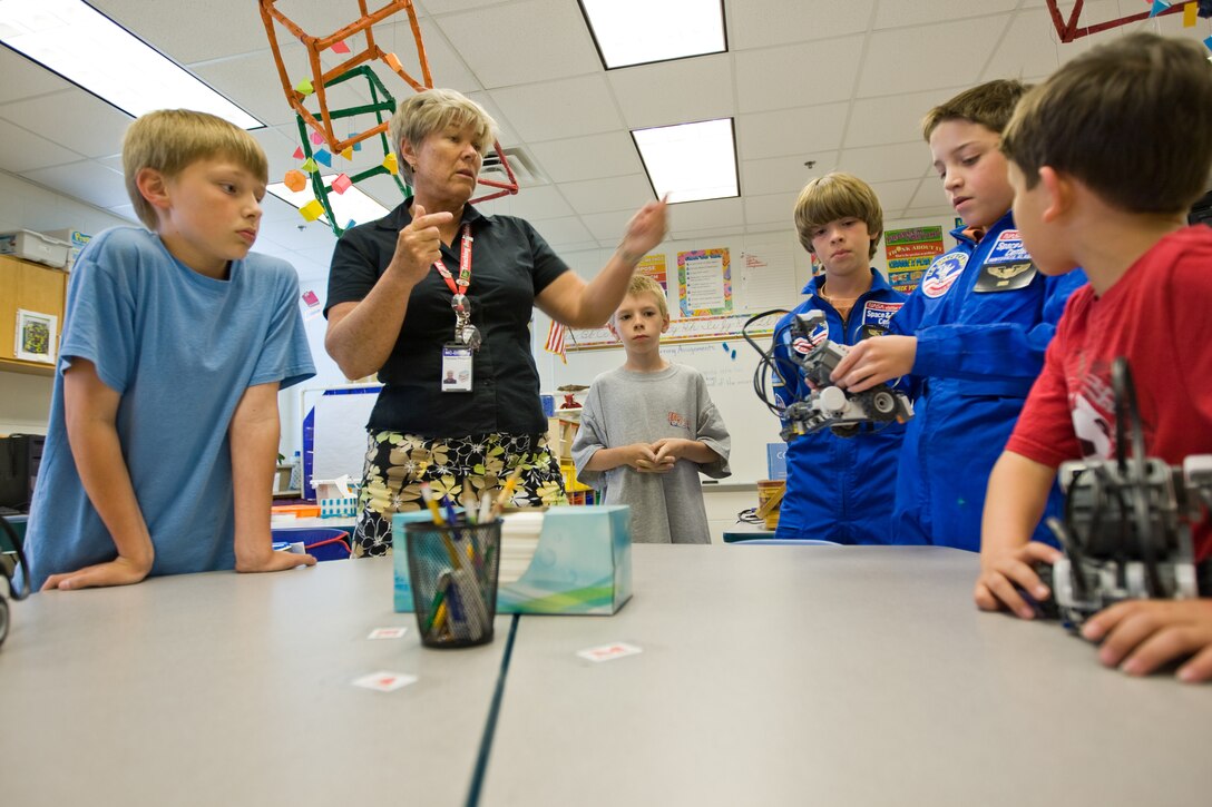 Pam Philpott, fourth grade educator at Bitz Intermediate School, discusses the importance of robotics in space exploration with students of the school’s science club, May 1.