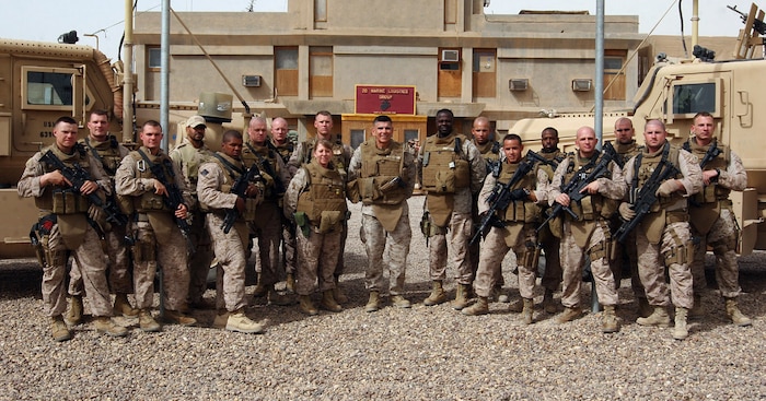 The 2nd Marine Logistics Group (Forward) commanding general, Brig. Gen. Juan G. Ayala, Command Master Chief Tammy Heap and the former sergeant major, Sgt. Maj. Carl Green, stand with the general's Personal Security Detail, at Camp Al Taqaddum, Iraq, May 1, 2009. Among the experienced 14-man team are military policemen, a Navy corpsman, a motor transportation operator, a communications specialist and infantrymen. (U.S. Marine Corps photograph by Sgt. Richard McCumber)