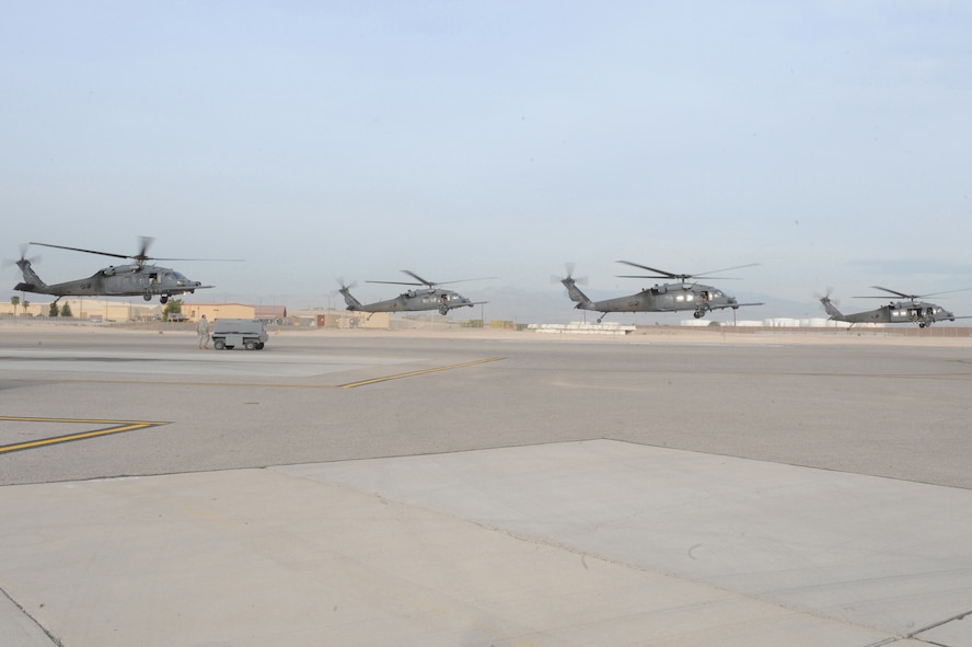 NELLIS AIR FORCE BASE, Nev.- Four HH-60G Pavehawk helicopters carrying approximately 24 Airmen from the 58th and 66th RescueSquadrons deploy for a real-world rescue mission May 1. The Airmen were requested by the Air Force Rescue Coordination Center to assist in the search for a pilot and passenger who were aboard a motorized sailplane that disappeared from radar in the Sierra Nevada Mountain Range near Mammoth Lakes, Calif., April. 24.  The aircraft was flying between Tonopah, Nev., and Modesto, Calif., and a search began about an hour after the plane was overdue.  As of April 30, the Civil Air Patrol and other agencies had flown more than 140 sorties in a 2,500 square-mile search area. The Air Force Rescue Coordination Center requested the assistance of the Nellis-based aircraft May 1, and within an hour of arriving on scene, the search ended when an HH-60 aircrew spotted and positively identified the missing aircraft.  The 58th and 66th Rescue Squadrons are subordinate units of the 23rd Wing based at Moody Air Force Base, Ga.(U.S. Air Force photo by/Senior Airman Nadine Y. Barclay/RELEASED)