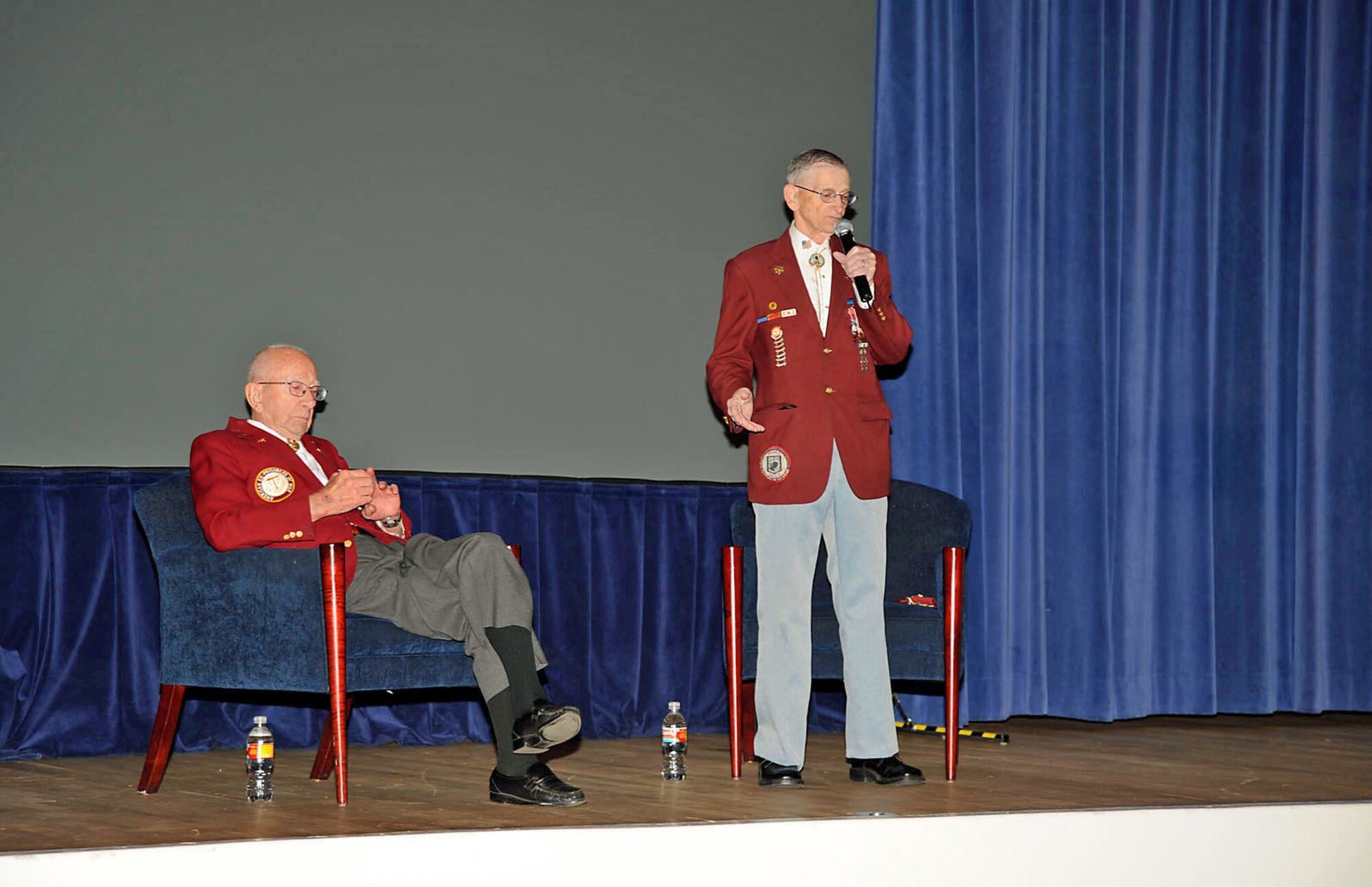 Master Sgt. (Ret.) Edwin Beck, speaks to an audience of approximately 200 at the base auditorium April 21 while Lt. Col. (Ret.) Bill Sheaves Jr. (right) listens. Sergeant Beck and Colonel Sheaves supported the Air Force’s Year of Leadership program by speaking to Peterson Airmen on the importance of character. Both men are World War II and Korean Conflict veterans. Colonel Sheaves is also a Vietnam War veteran. Colonel Sheaves and Sergeant Beck are both prior prisoner’s of war. Sergeant Beck said that while being a POW was the “worst situation imaginable,” he maintained confidence in his country, even while being interrogated. (Air Force photo by Roberta McDonald)

