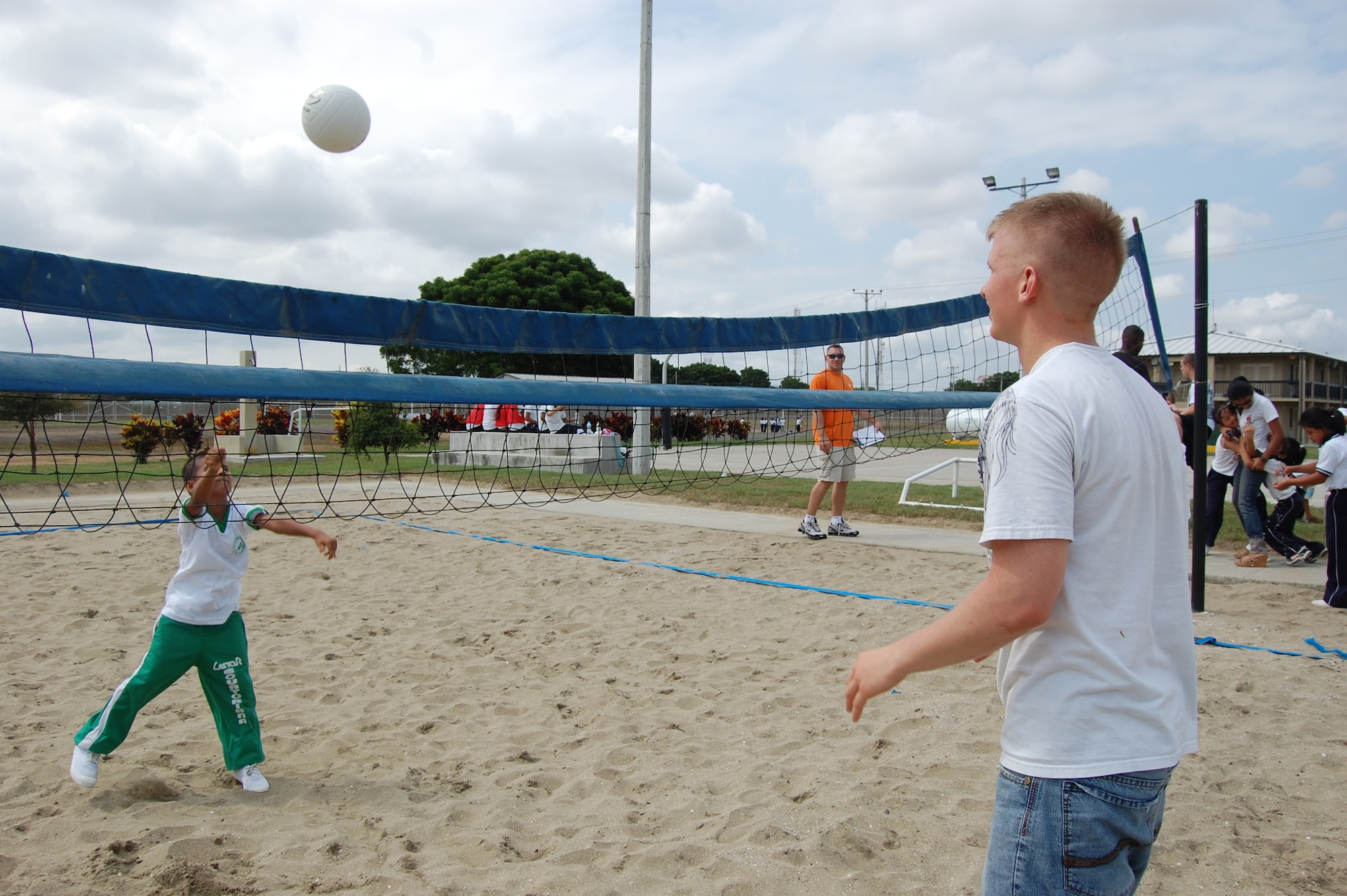 Airman 1st Class Cory Bay (right), 478th Expeditionary Operations Squadron security forces apprentice, teaches volleyball during a sports day here with students from Manta, Ecuador's Angelica Flores special needs school April 25. FOL Manta hosted the all-day event to teach 40 students American sports and build their teamwork and confidence. (U.S. Air Force photo by 1st Lt. Beth Woodward)