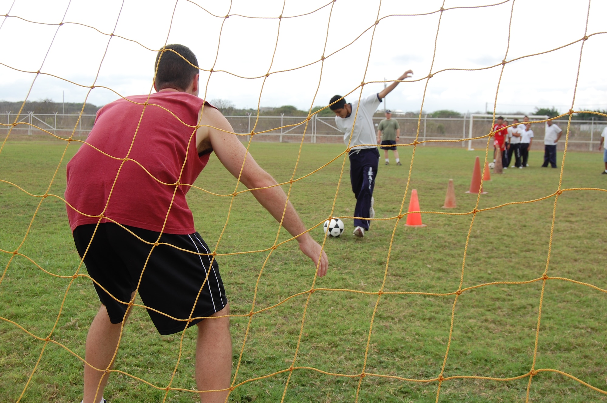 Maj. Chris Shea (far left), 478th Expeditionary Operations Squadron assistant director of operations, defends a soccer goal during a sports day here with students from Manta, Ecuador's Angelica Flores special needs school April 25. FOL Manta hosted the all-day event to teach 40 students American sports and build their teamwork and confidence. (U.S. Air Force photo by 1st Lt. Beth Woodward)