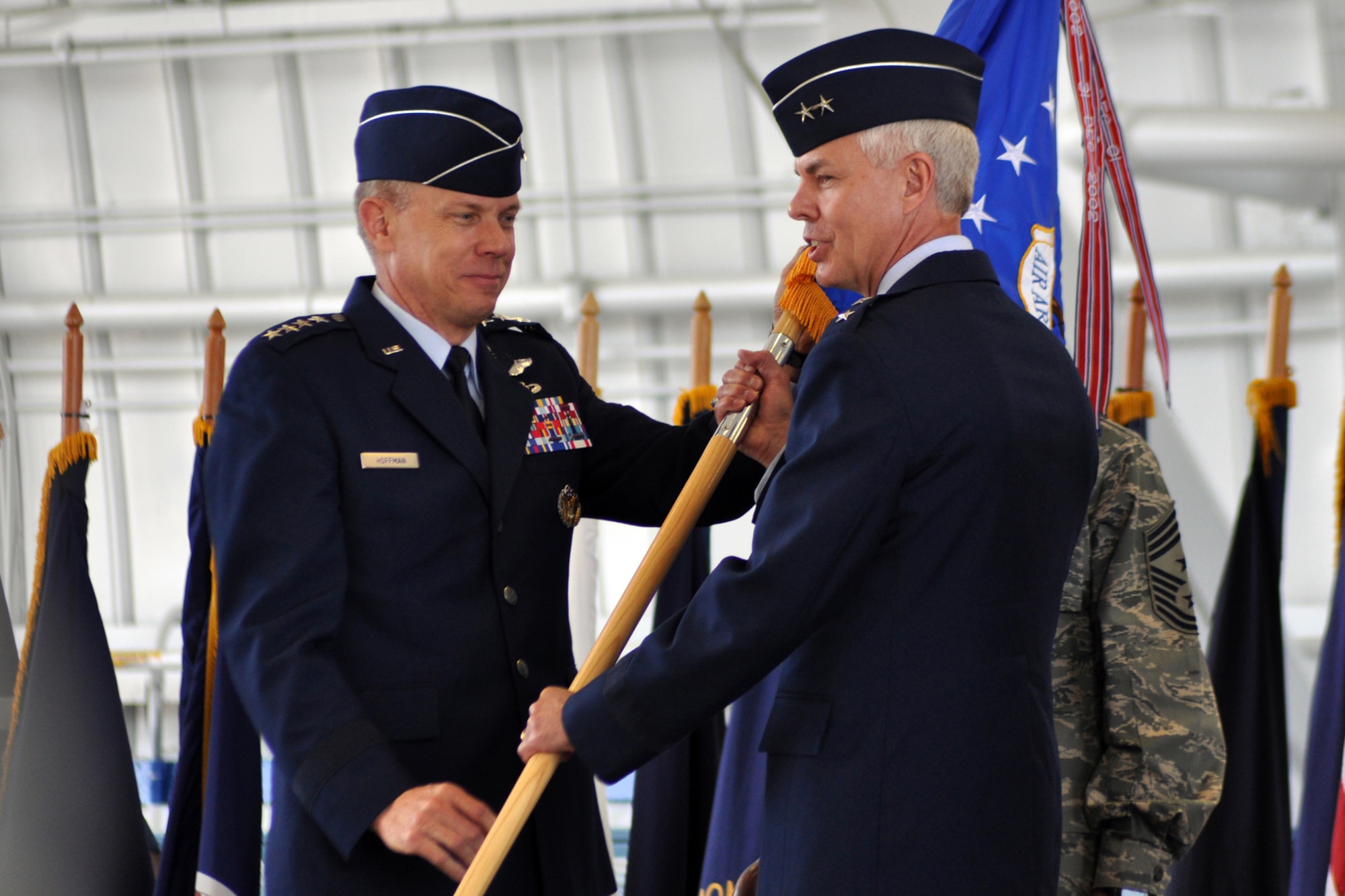 EGLIN AIR FORCE BASE, Fla. -- Gen. Donald Hoffman, Air Force Material Command commander, hands Maj. Gen. Charles R. Davis the Air Armament Center guide-on during the AAC change-of-command ceremony May 1. General Davis took command of the AAC from Maj. Gen. David Eidsaune during the ceremony. The change-of-command ceremony is a time-honored military tradition symbolizing the continuity of authority as command is passed from one individual to another. (U.S. Air Force photo/ Airman Anthony Jennings)
