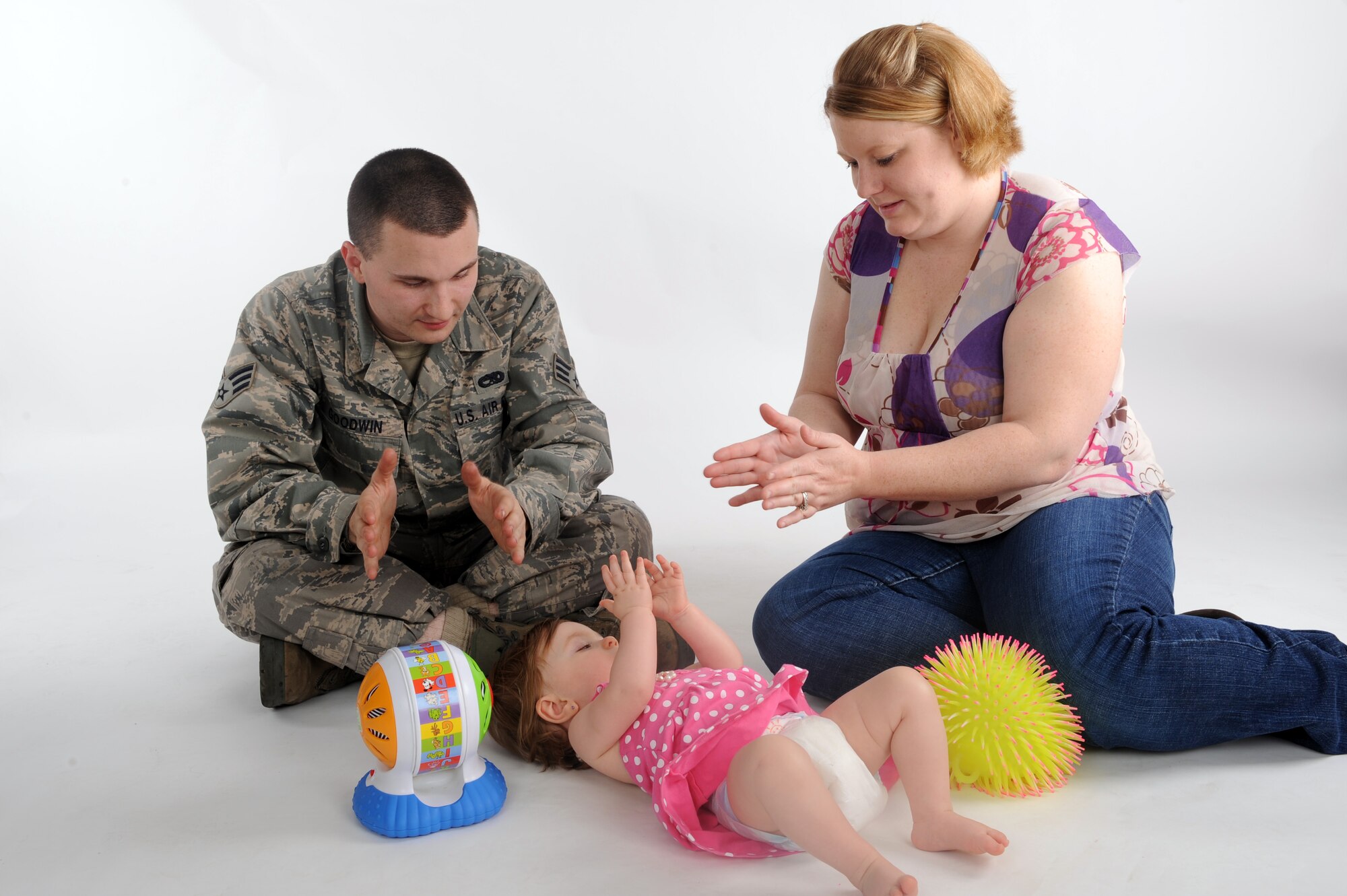 Senior Airman Derek Goodwin, 2d Maintenance Squadron, and his wife Stormy play with their daughter Skyler. Skyler was diagnosed with Septo-optic Dysplasia when she was three-months-old. The cause of SOD is unknown, but genetics do not play a factor in the disorder. (U.S. Air Force photo by Senior Airman Joanna M. Kresge)