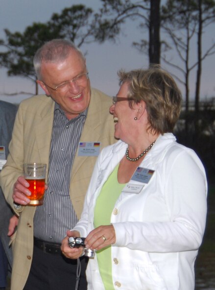 Erich Jung and Ruth Leppla, German civic leaders invited to attend the U.S. Air Forces in Europe Civic Outreach Tour, share a laugh at the Tyndall Air Force Base, Fla., Heritage Club during a special dinner held in their group's honor April 29. The 18 civic leaders in the group toured various Tyndall units earlier in the day and were later presented with custom souvenir posters of the F-22 Raptor. (U.S. Air Force photo/Lisa Norman) 