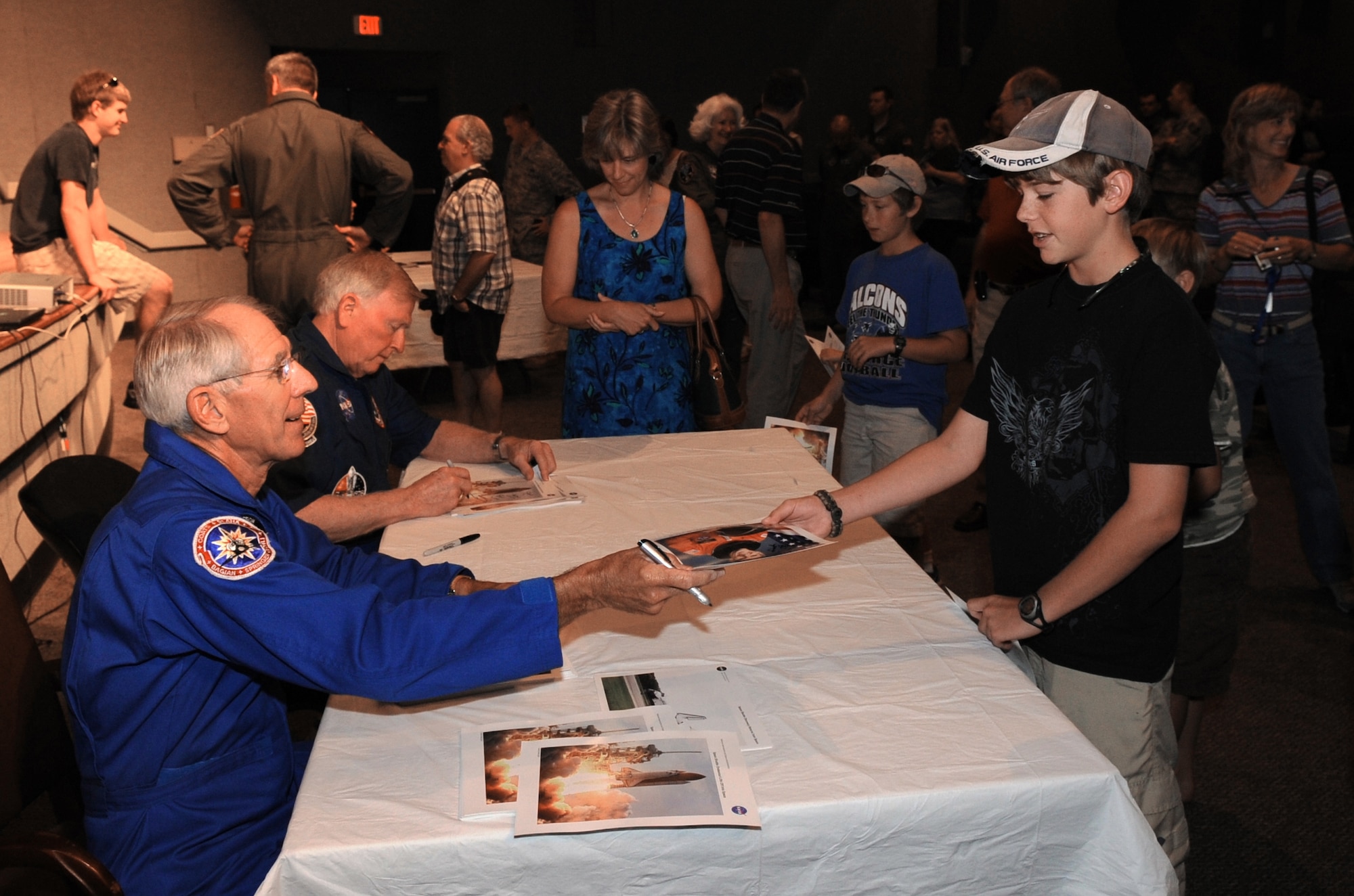Former astronauts Bob Springer and Jon McBride sign autographs for children following the astronaut panel held by Det. 3  45th Operations Group officials April 24 at Patrick Air Force Base, Fla. (U.S. Air Force photo/John Connell) 
