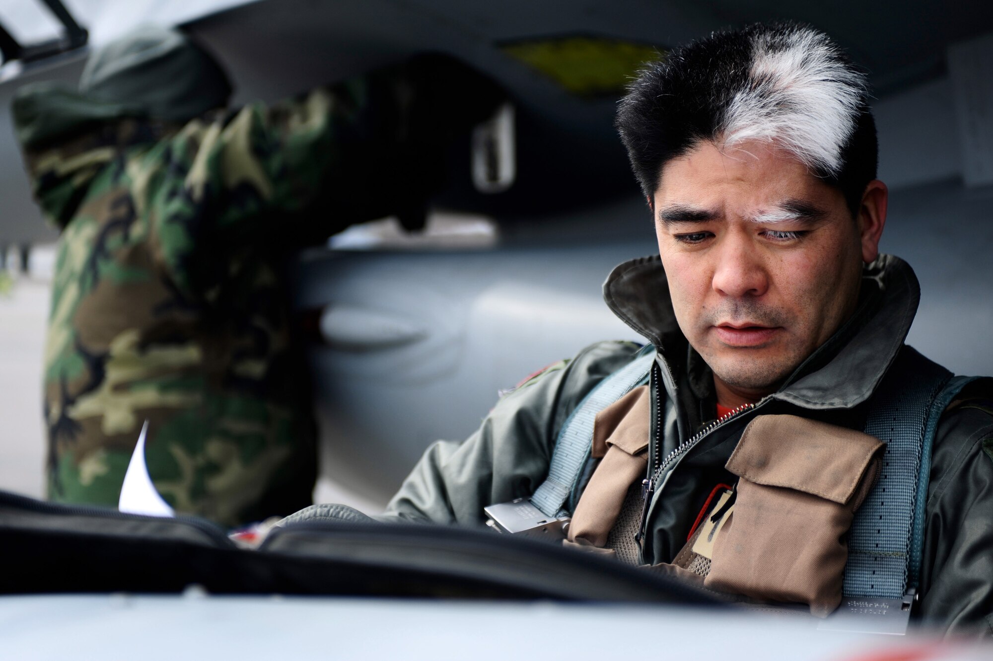 Lt. Col. Michael Kato reads his preflight inspection checklist during Red Flag-Alaska 09-2 April 24 at Eielson Air Force Base, Alaska. This exercise provides unique opportunities to integrate various forces into joint, coalition and bilateral training from a simulated forward operating base. Colonel Kato is assigned to the 124th Fighter Squadron at Des Moines, Iowa. (U.S. Air Force photo/Senior Airman Jonathan Snyder)