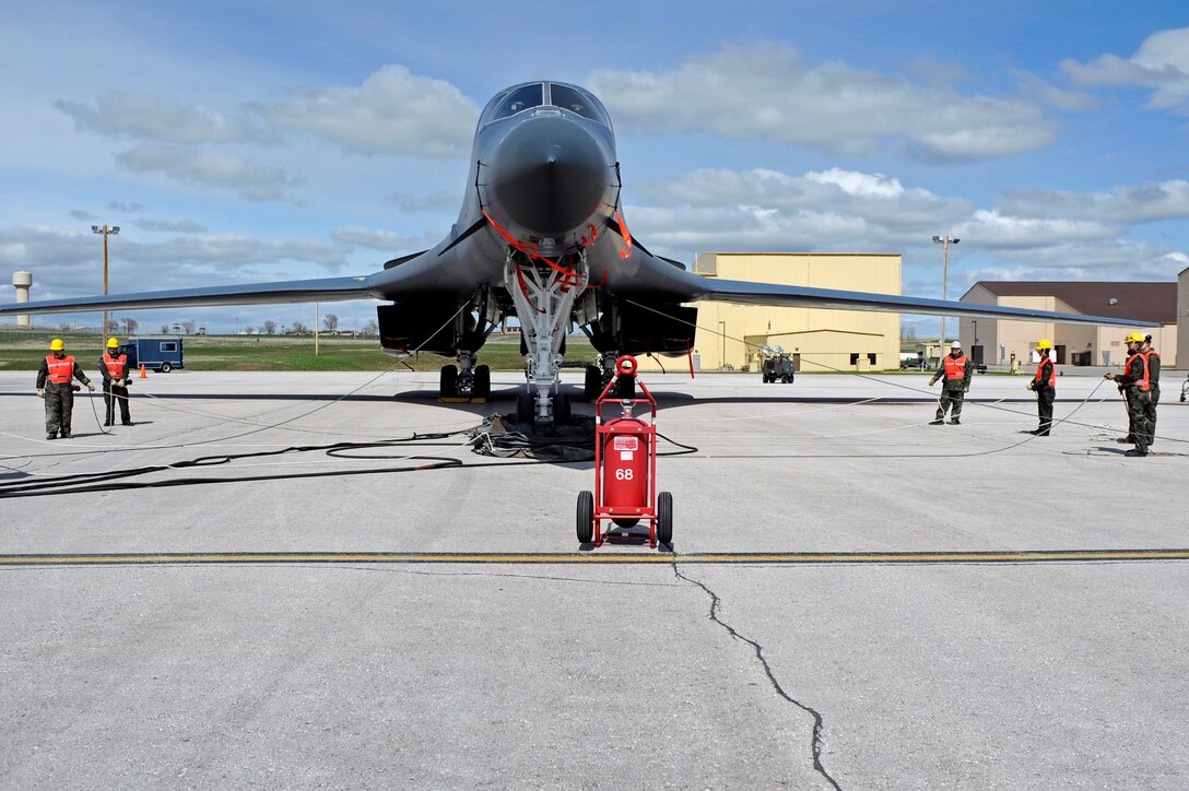 Members of the Ellsworth crash team simulate inflating and positioning aircraft lift bags under the nose of a B-1B Lancer here, April 30.  The crash team was responding during a major accident response exercise in preparation for an upcoming air show. (U.S. Air Force photo/Airman 1st Class Matthew Flynn)