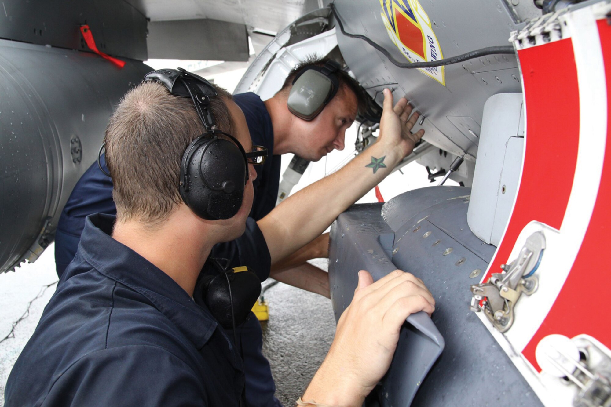 Senior Airman Matthew Golitko and Staff Sgt. Stephen Zych, 63rd Aircraft Maintenance Unit crew chiefs, prepare an F-16 for take-off April 23 during Balikatan 2009. (U.S.M.C. Lance Cpl. Cristina Noelia Gil.)