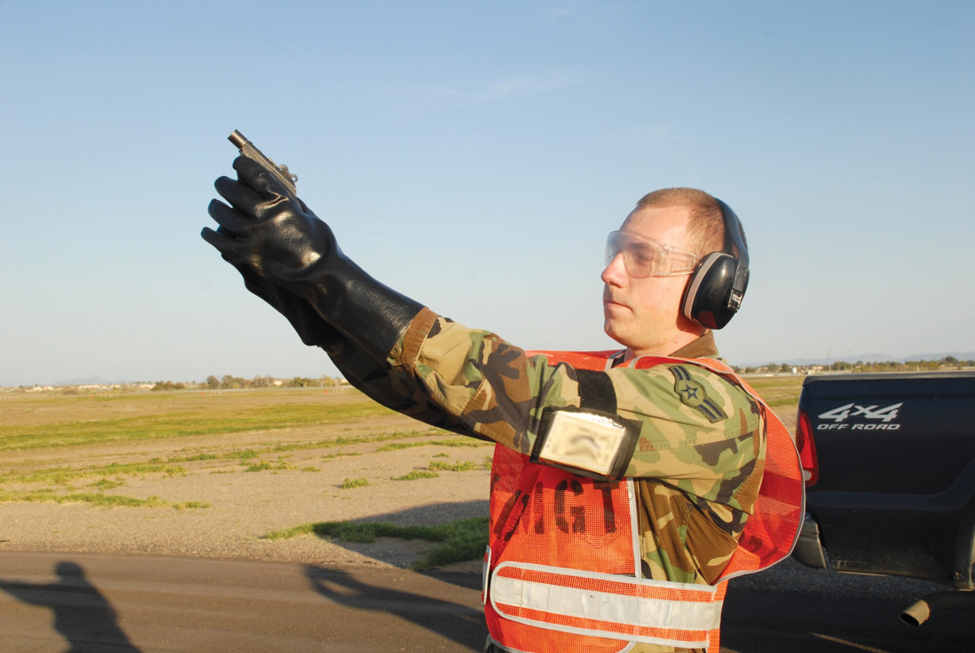 Airman 1st Class Lawrence Stephens, 56th Operations Support Squadron airfield management operations coordinator, fires off pyrotechnics for bird dispersal on the Luke Air Force Base flightline.(U.S. Air Force photo/ Airman 1st Class Tracie Forte.)