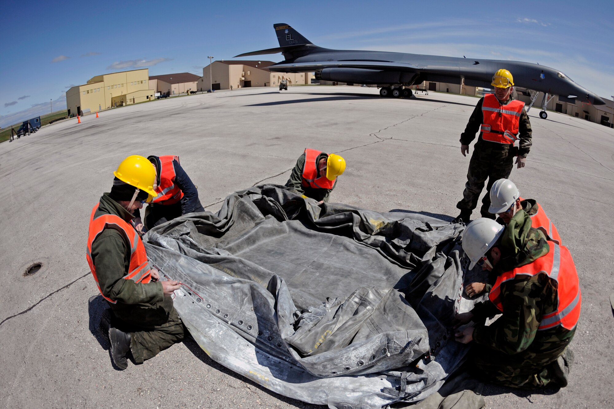 Members of the Ellsworth crash team assemble aircraft lift bags during a major accident response exercise here, April 30.  The crash team responded to a simulation of a B-1B Lancer receiving nose damage. (U.S. Air Force photo/Airman 1st Class Matthew Flynn)
