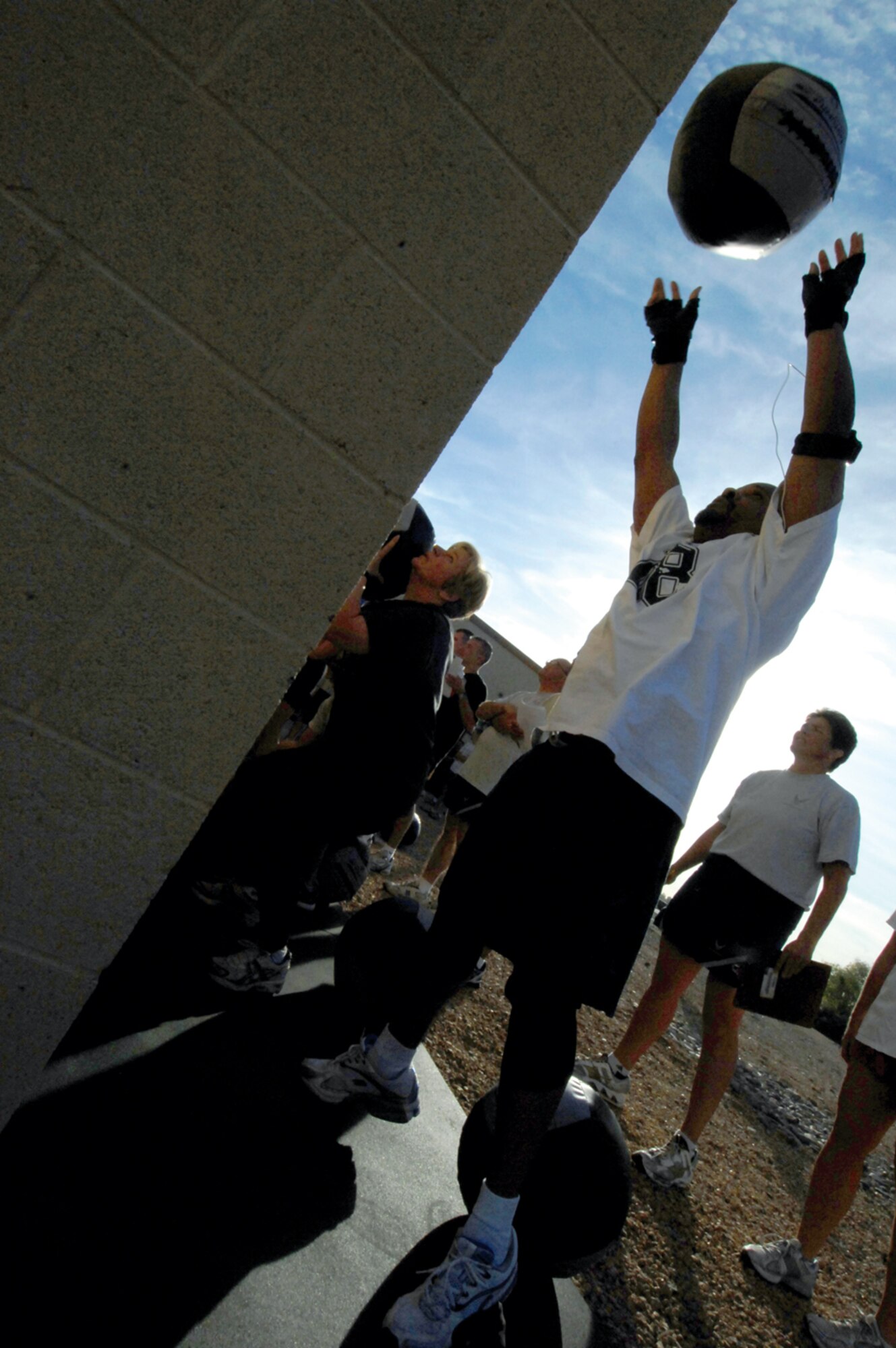 Members of the 56th Fighter Wing staff agencies perform the wall ball portion of the CrossFit Challenge. (U.S. Air Force photo/ Tech. Sgt. Jeffery Wolfe.)
