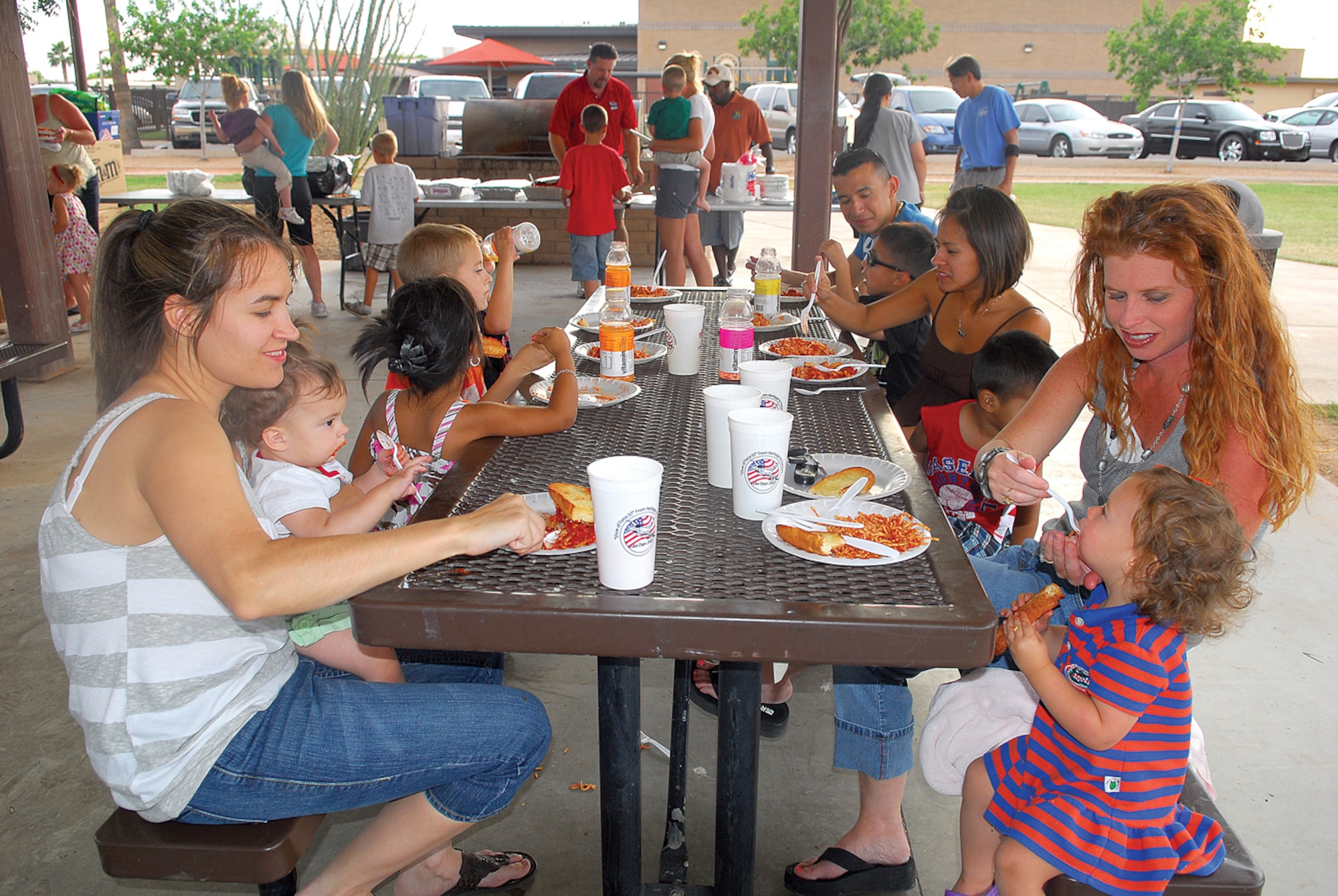 Members of the Luke community enjoy pasta and garlic bread donated by Sabatino’s Pizza, Pasta, and Wings during the camp out. (U.S. Air Force photo/ Airman 1st Class Traci Forte.)