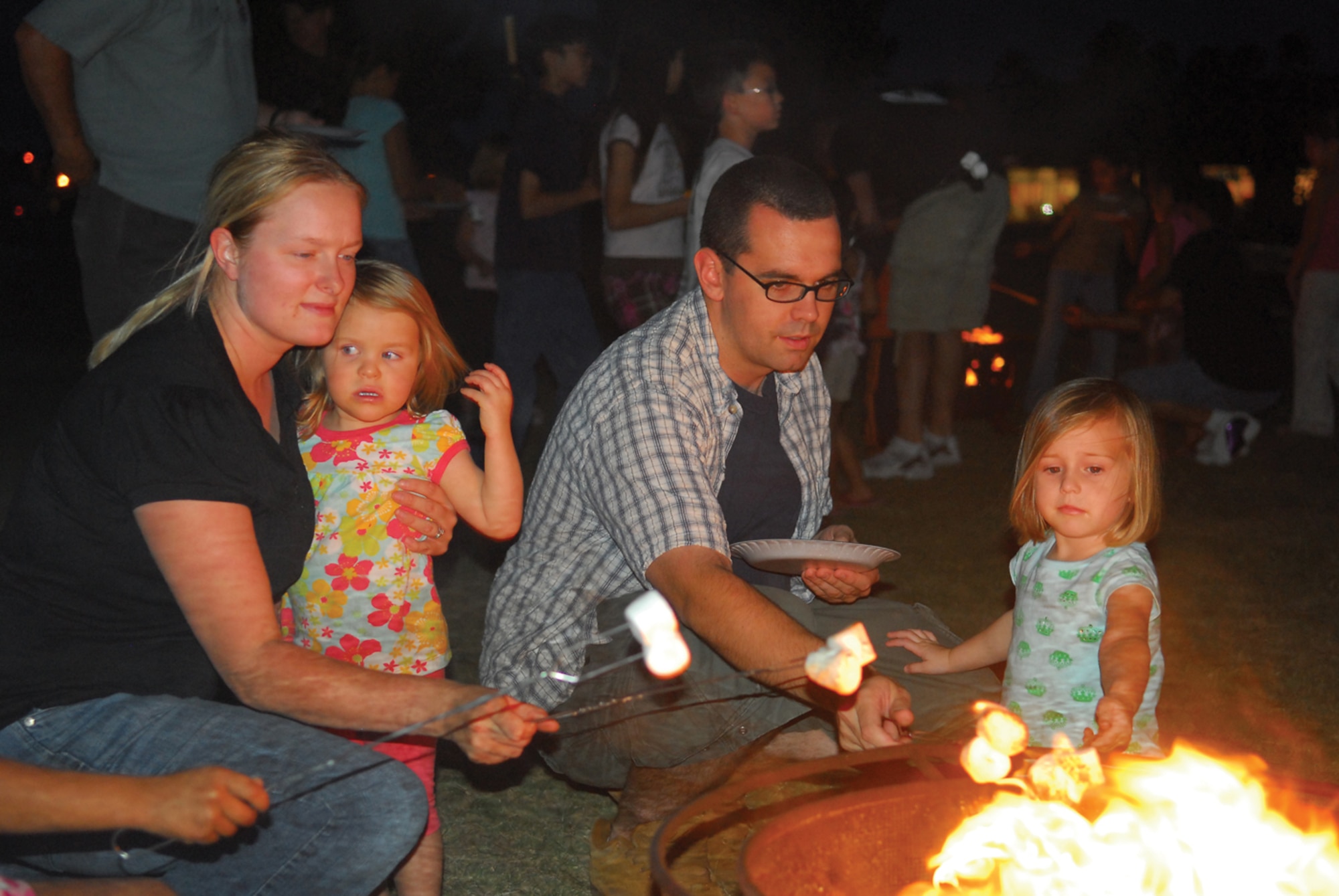 Members of the Luke community roast marshmallows on a bonfire during the Luke Air Force Base Spring Family Camp Out at Fowler Park April 24. (U.S. Air Force photo/ Airman 1st Class Traci Forte.)
