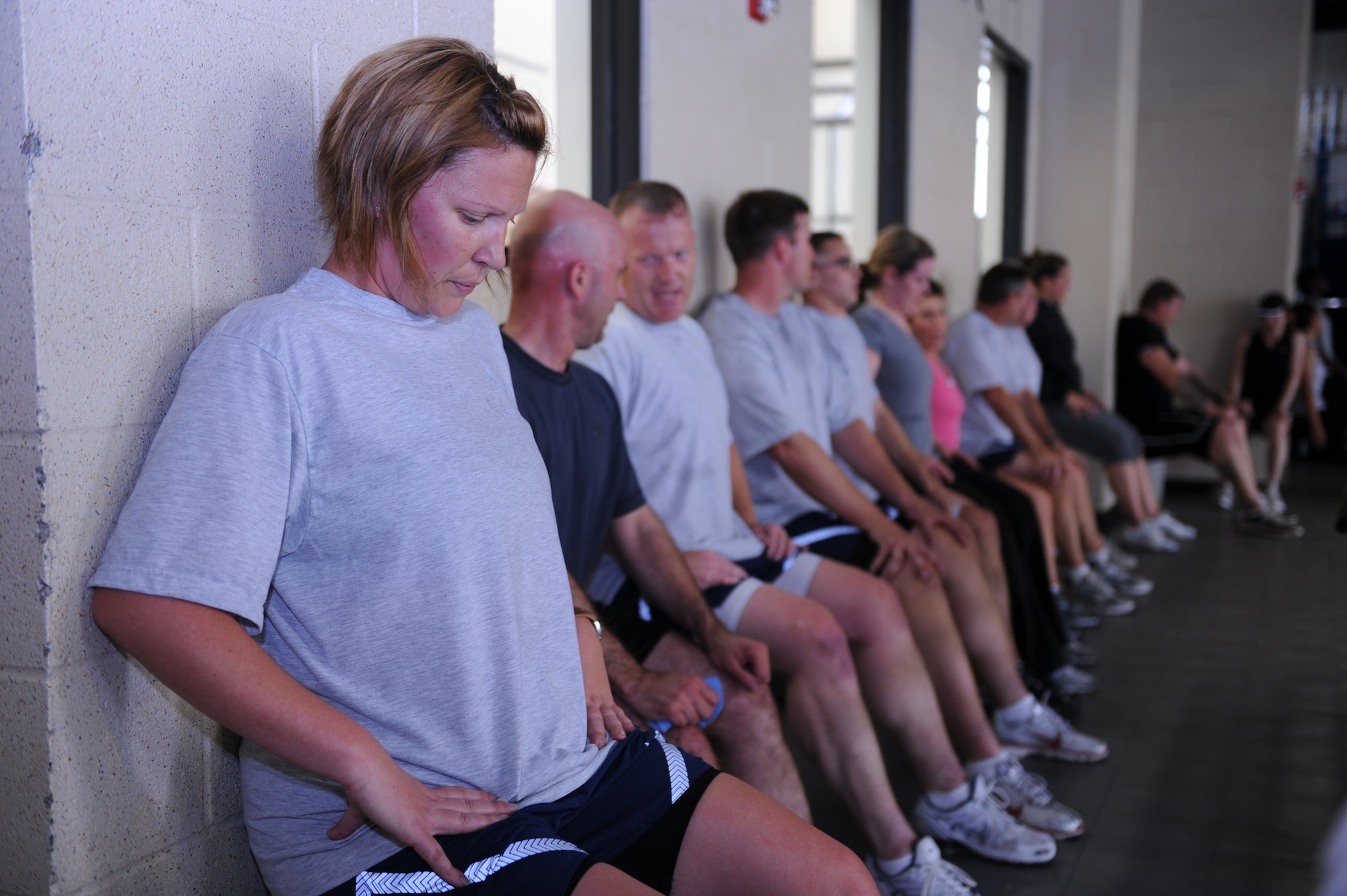 Staff Sgt. Shannon Cole, 19th Equipment Maintenance Squadron isochronal inspection dock supply liaison, keeps herself steady in a wall sit position during a burn hour session at the fitness center Monday.