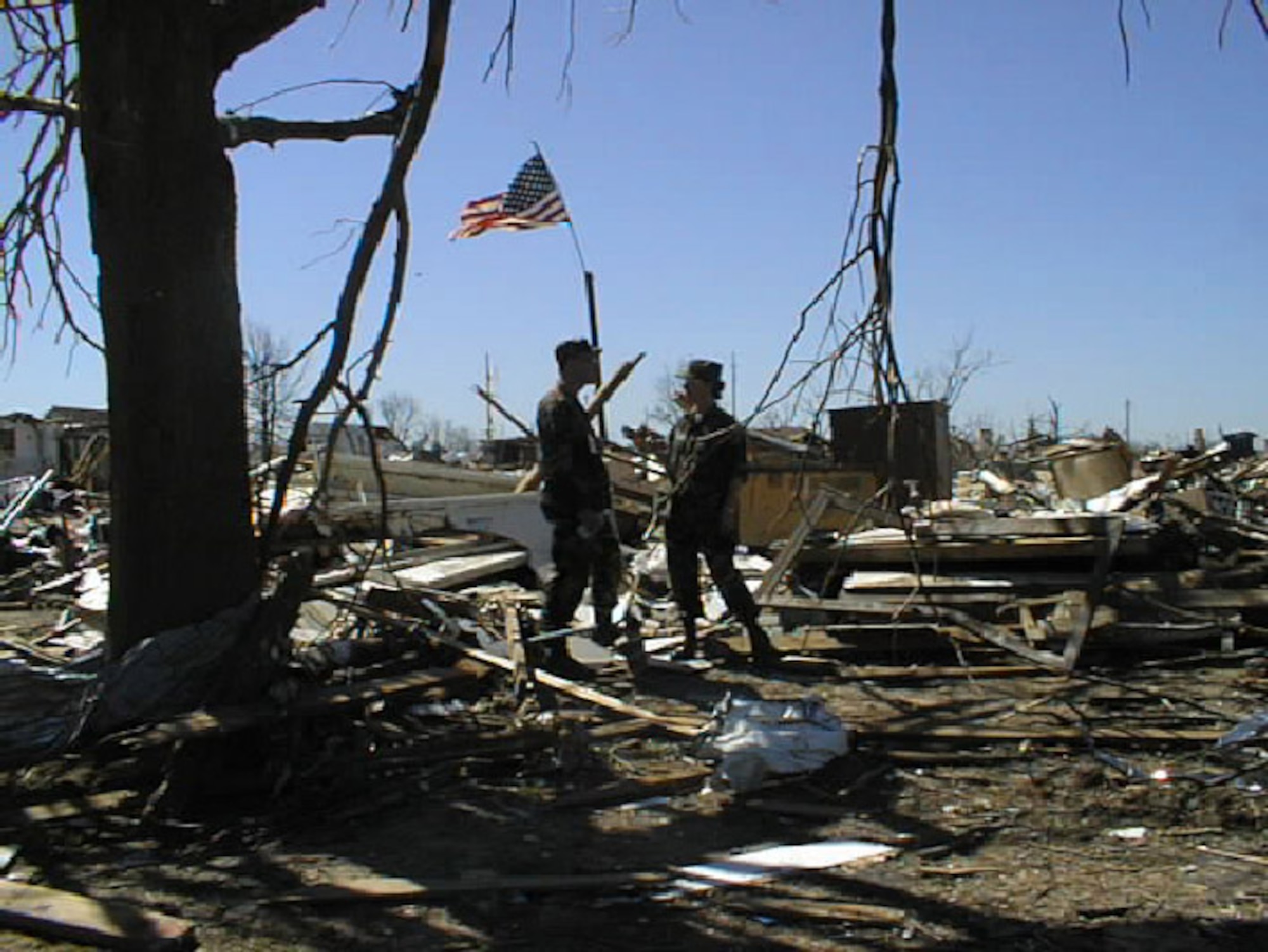 Second Lieutenant Stan Paregien and TSgt. Melba Koch pause during search and recovery team efforts to report results.  Dozens of Tinker Air Force Base employees responded to the call to join search teams during the aftermath of the 3 May 1999 tornado. (1999 file photo)