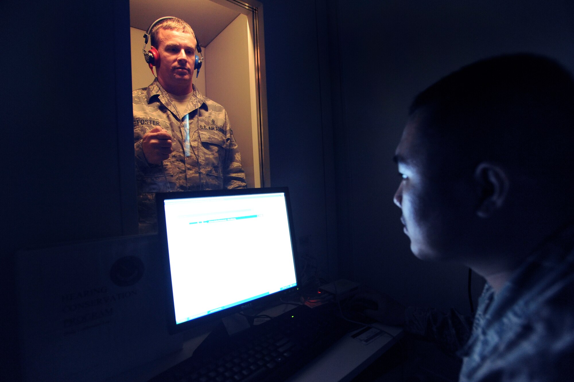 Tech. Sgt. Duwayne Foster, NCOIC of public health and Staff Sgt. Rommel Hernandez, assistant NCOIC of public health for the 379th Expeditionary Medical Group, run an operations check on the new hearing test booth here, April 30, 2009, in an undisclosed location in Southwest Asia.  The base is the first in the U.S. Central Command's area of responsibility to have a hearing test booth.  Sergeant Foster is native to Mobile, Ala. and Sergeant Hernandez hails from Arlington, Va., both are deployed from Keesler Air Force Base, Miss., in support of Operations Iraqi and Enduring Freedom and Combined Joint Task Force - Horn of Africa.  (U.S. Air Force Photo by Staff Sgt. Joshua Garcia/released)