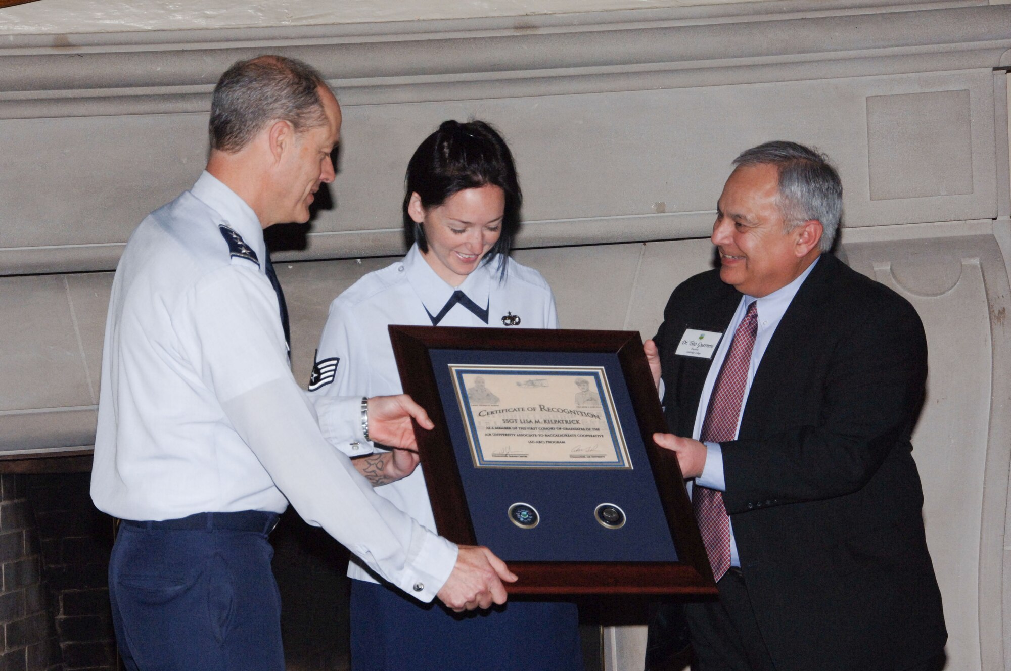 In honor of the first group of graduates of the Air University Associate-to-Baccalaureate Cooperative program, Lt. Gen. Allen Peck, Air University commander, and Tito Guerreo, Air University Board of Visitors chair, presented a plaque of recognition to Staff Sgt. Lisa Kilpatrick. Sergeant Kilpatrick, an Airman Leadership School instructor from Eglin Air Force Base, Fla., was one of the first to complete her ABC degree, accepted the plaque on behalf of all the members of the first cohort of ABC program graduates at a BOV luncheon at the Maxwell Officers Club April 22. At the event, board members had the opportunity to talk with current students of the program about their experiences, and the education they are receiving. (U.S. Air Force photo by Melanie Rodgers Cox)