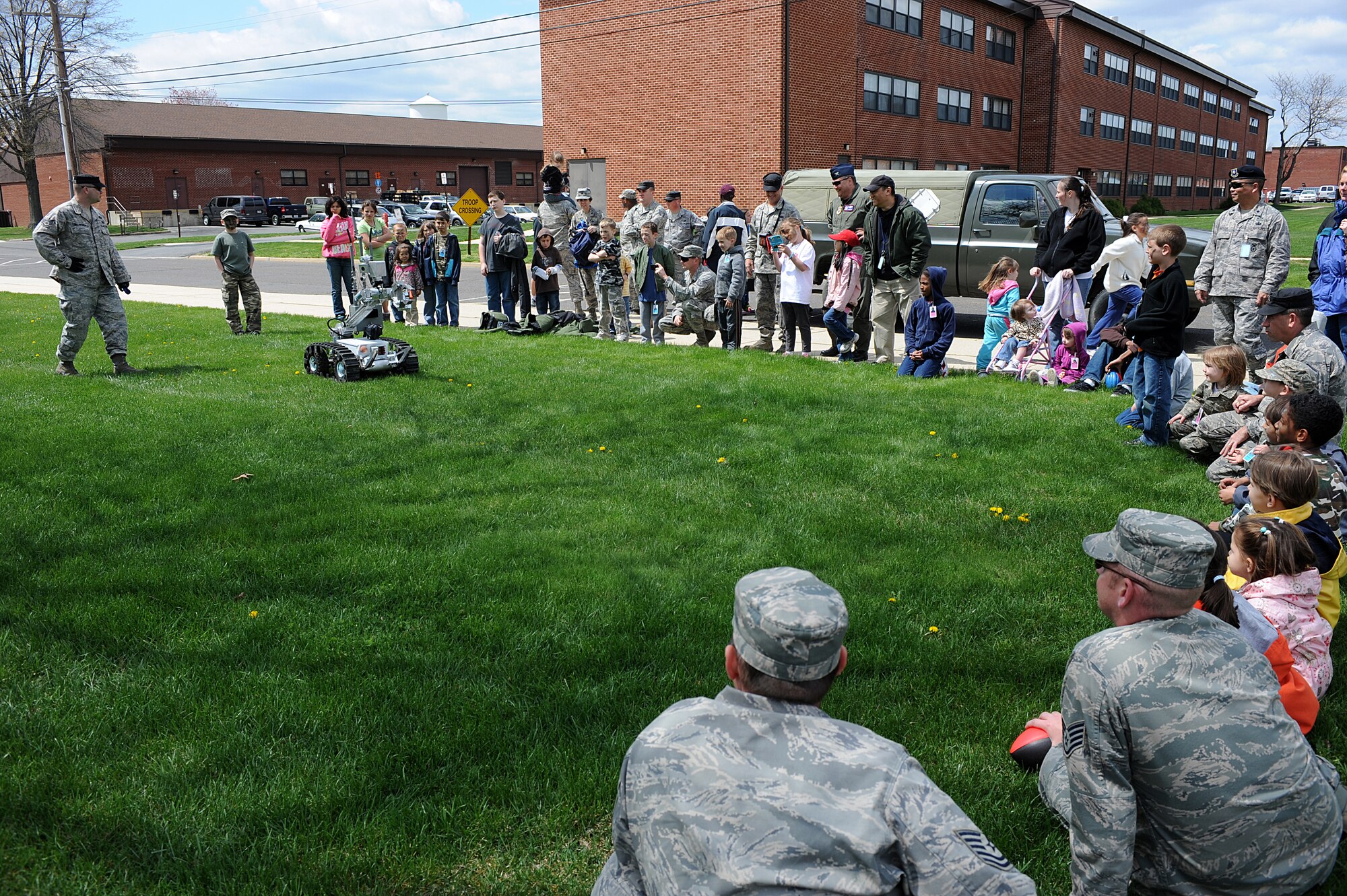 U.S. Air Force Expeditionary Center Airmen and their children observe an Explosive Ordinance Disposal team robot during a demonstration April 23 as part of "Bring Your Child to Work Day" at the U.S. Air Force Expeditionary Center on Fort Dix, N.J.  The day included physical training, vehicle static display, a military working dog demo and explosive ordinance disposal demo.   (U.S. Air Force Photo/Staff Sgt. Nathan G. Bevier) 
