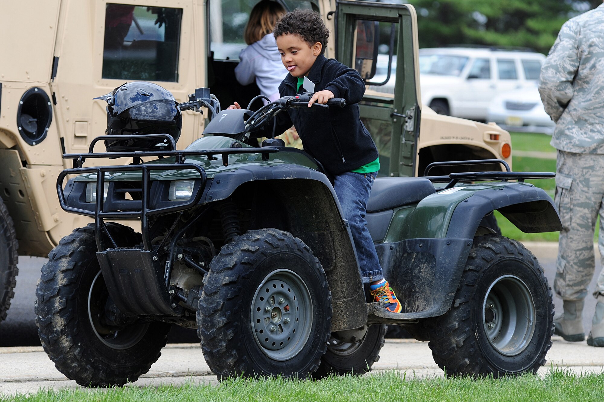 Caleb, 4 year old son of Staff Sgt. Donald and Taccora Jones, sits on a 4-wheeler, April 23 during a military vehicle static display as part of "Bring Your Child to Work Day" at the U.S. Air Force Expeditionary Center on Fort Dix, N.J.  The day included physical training, vehicle static display, a military working dog demo and explosive ordinance disposal demo.   (U.S. Air Force Photo/Staff Sgt. Nathan G. Bevier) 