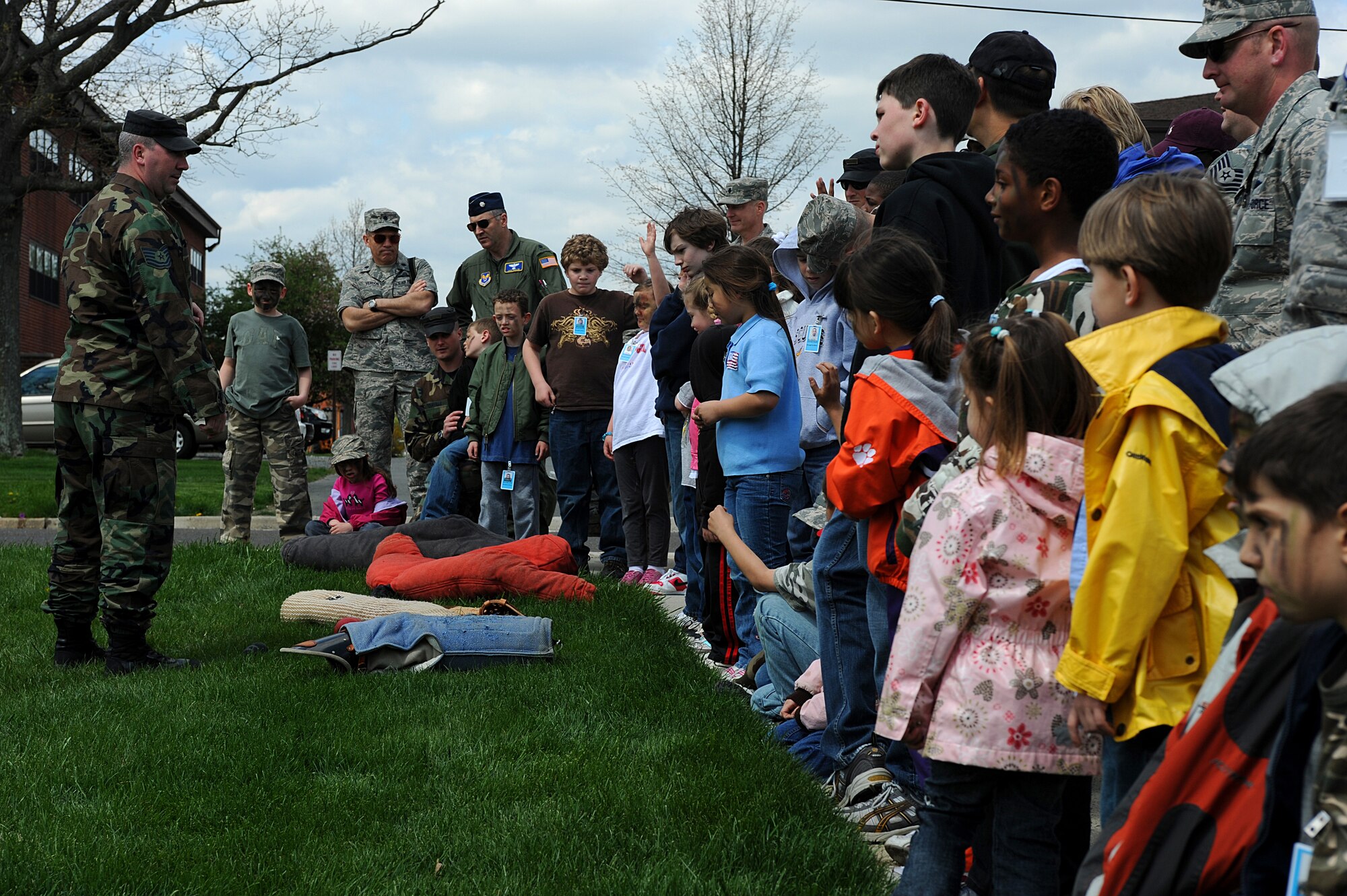 Tech. Sgt. Jeffery Dean, 421st Combat Training Squadron military working dog instructor, briefs U.S. Air Force Expeditionary Center Airmen and their children on the military working dog demo April 23 as part of "Bring Your Child to Work Day" at the center on Fort Dix, N.J.  The day included physical training, vehicle static displays, a military working dog demo and explosive ordinance disposal demo.   (U.S. Air Force Photo/Staff Sgt. Nathan G. Bevier) 