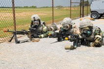 Members of the 908th Airlift Wing take up a defensive position along the Blue Thunder perimeter fence during the Patriot Thunder Operational Readiness Training Program exercise held April 23-30. The exercise was conducted in preparation for an up-coming Operational Readiness Inspection scheduled for December. (U.S. Air Force photo by Jamie Pitcher)