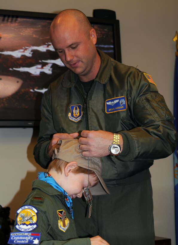 YOUNGSTOWN AIR RESERVE STATION, Ohio — Air Force Reserve Capt. Brian Hodor, a C-130 pilot with the 757th Airlift Squadron, dons dog tags over newly honorary commissioned 2nd. Lt. Tyler Jordan.  Eight-year old Tyler is the latest honoree under the 910th Airlift Wing's tenth annual Pilot for a day program.  Tyler is currently being treated for Cerebral Palsy. The annual program, sponsored by the Youngstown Air Reserve Base Community Council, and supported by Akron Children's Hospital of the Mahoning Valley aims to brighten the day of select children who suffer from chronic or life threatening illnesses.  Select children are taxied about a C-130 airplane, along with many interactive base activities.  U.S. Air Force Photo/Maj. Brent J. Davis