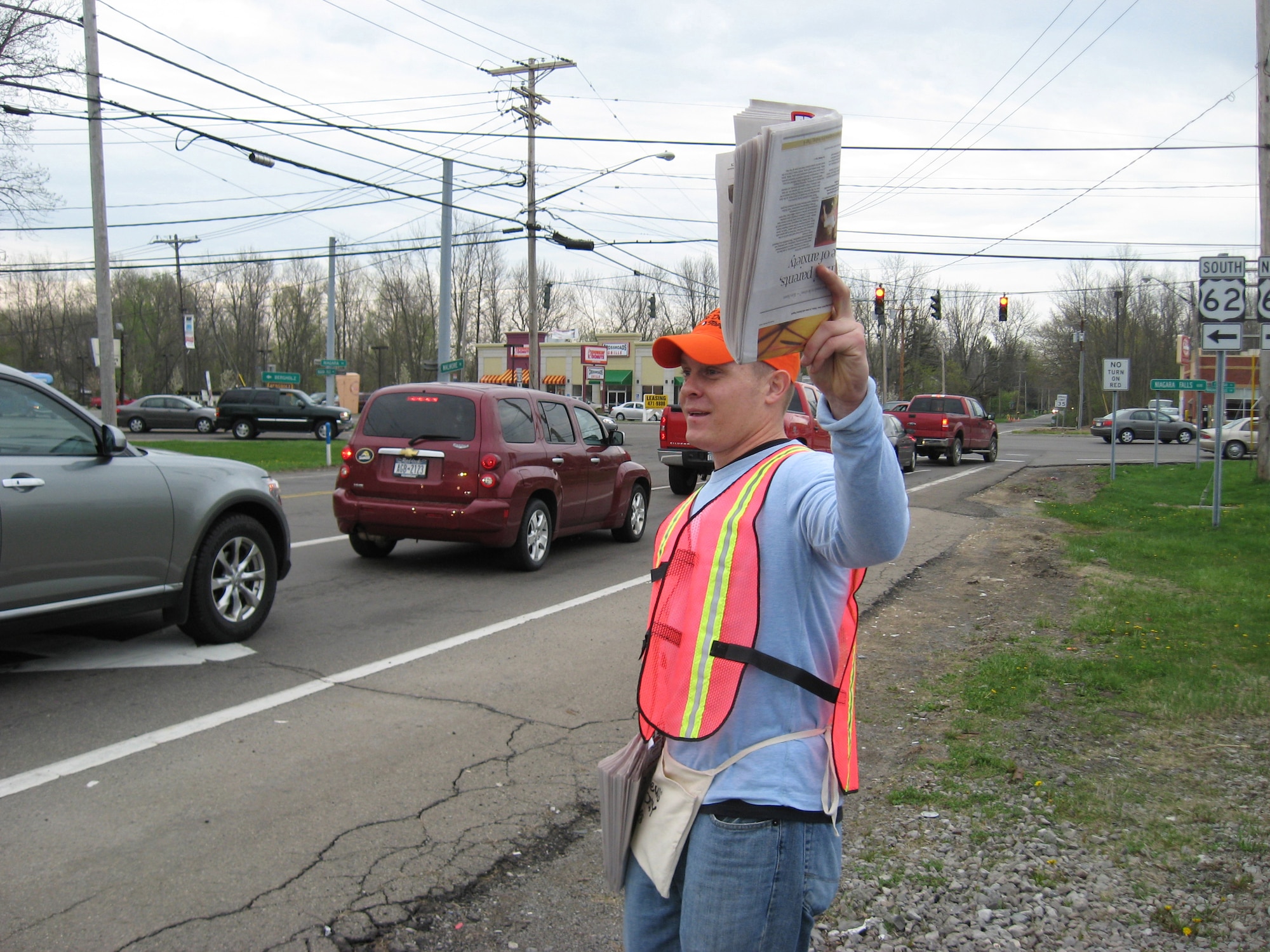 Tech. Sgt. Robert Mathewson, 107th AW, spent his morning chasing down cars during the rush hour commute. His mission, exchange a special edition Buffalo Newspaper for a buck. His efforts paid off, selling more papers and raising more cash than previous years.   (U.S. Air Force photo/Tech. Sgt. Jennifer Weerheim)

