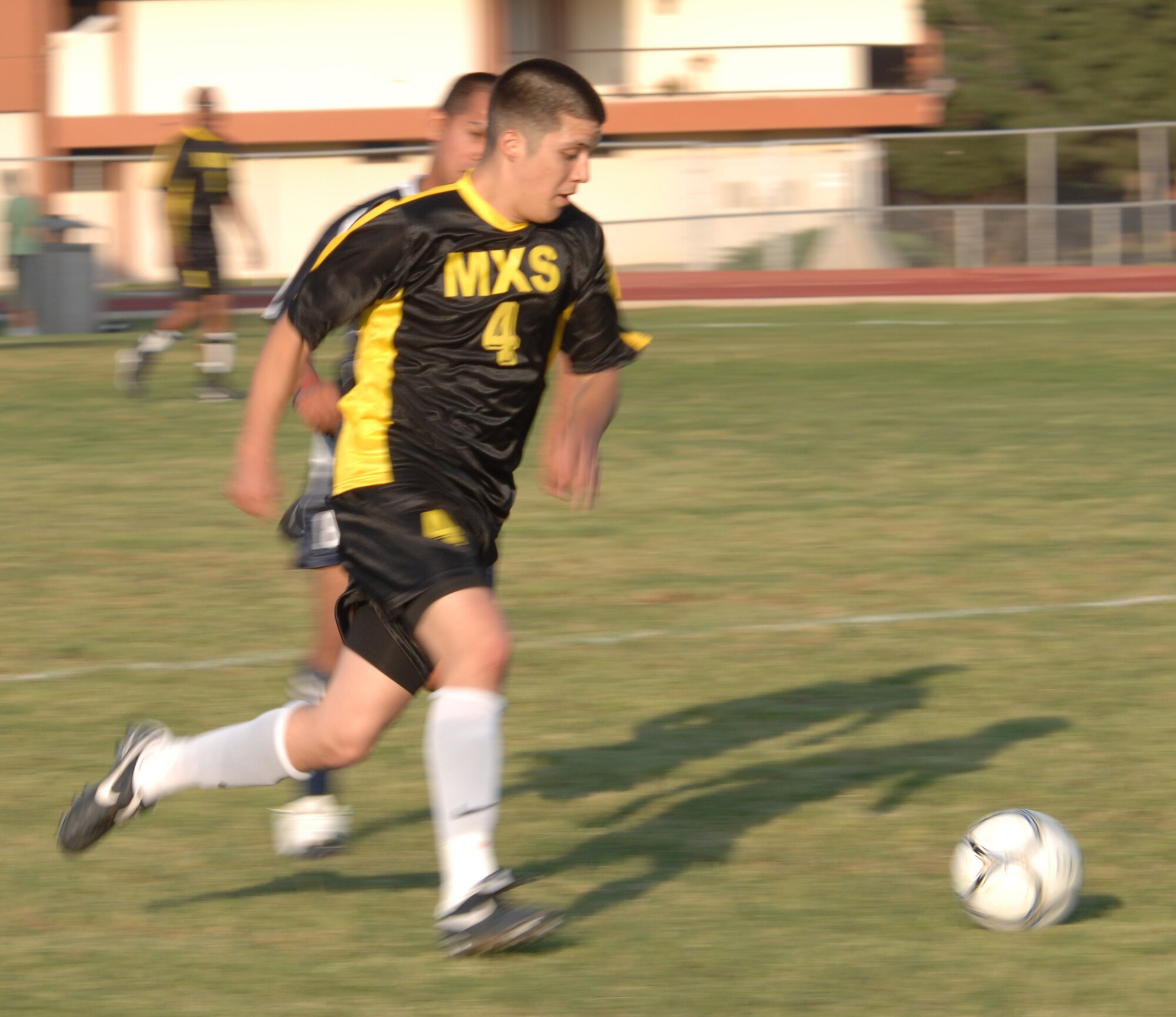 Airman Alan Esqueda, 39th Maintenance Squadron team, dribbles the ball down the field during an intramural soccer game at Incirlik Air Base, Turkey, April 28, 2009. The game resulted in a tie score of 2-2. The intramurals are made up of nine squadron teams. (U.S. Air Force photo/Staff Sgt. Lauren Padden)