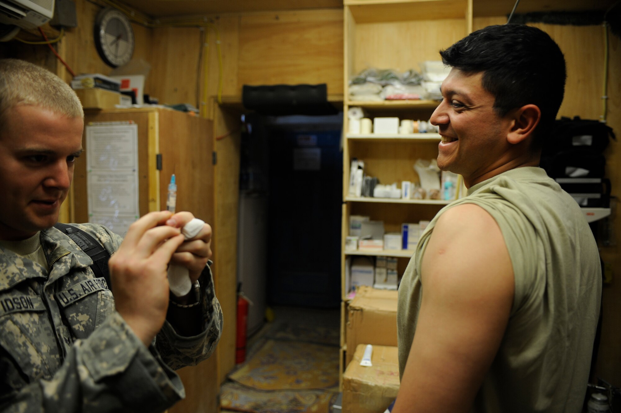 U.S. Air Force Senior Airman Michael Davidson, a medical technician with the Paktya Provincial Reconstruction Team, prepares to give a routine vaccination to Staff Sgt. Nestor Sosa, a vehicle maintainer with the Paktya PRT, April 14, 2009, at Forward Operating Base Gardez. (U.S. Air Force photo by Staff Sgt. Shawn Weismiller)