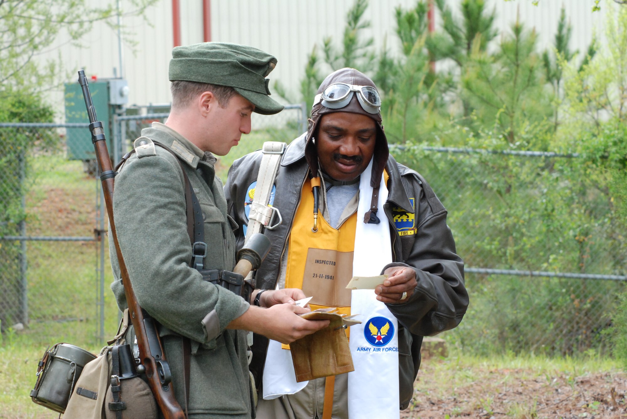 Master Sgt. Michael Varnado, 700th Airlift Squadron Life Support  NCO, dressed as a World War II Tuskegee Airman fighter pilot, exchanges information with WWII German soldier reenactor Clayton David during the Annual World War II Heritage Days event at Peachtree City Airport April 19.  The Commemorative Air Force Dixie Wing, a local patriotic organization hosted its sixth annual event on April 18-19 to pay tribute to the veterans of WWII and all of America’s veterans.  (U.S. Air Force photo/Master Sgt Stan Coleman)