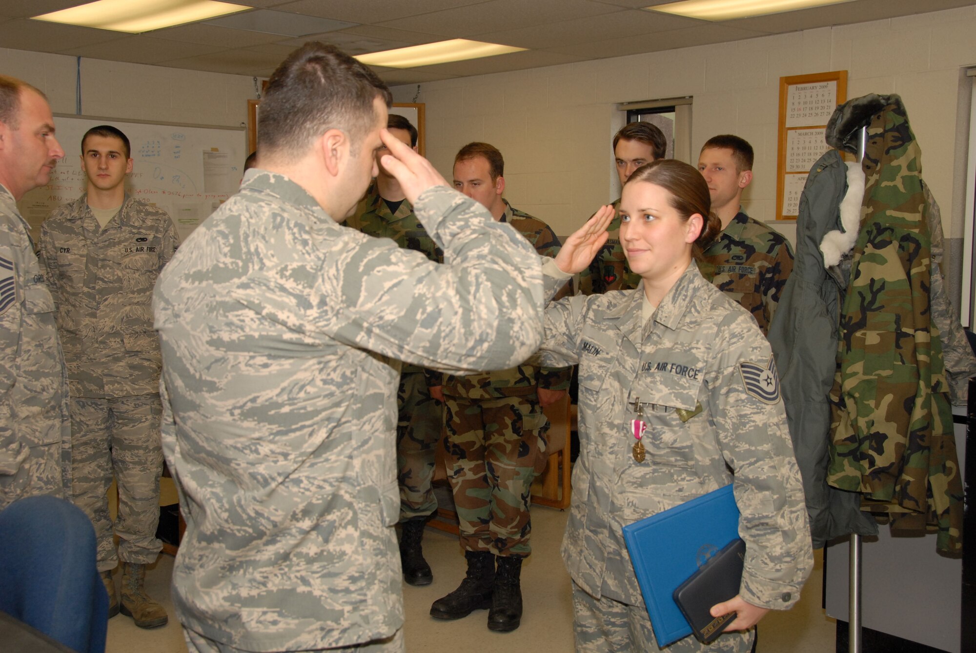 Tech. Sgt. Carey Malin, avionics specialist, 103rd Avionics Flight, salutes Maj. Wayne B. Ferris, maintenance squadron commander, 103rd Maintenance Squadron, after receiving her Meritorious Service Medal during a ceremony on base April 5th, 2009.  Malin was awarded the medal for her contributions to the honor guard.  (U.S. Air Force photo by Staff Sgt. Erin McNamara)
