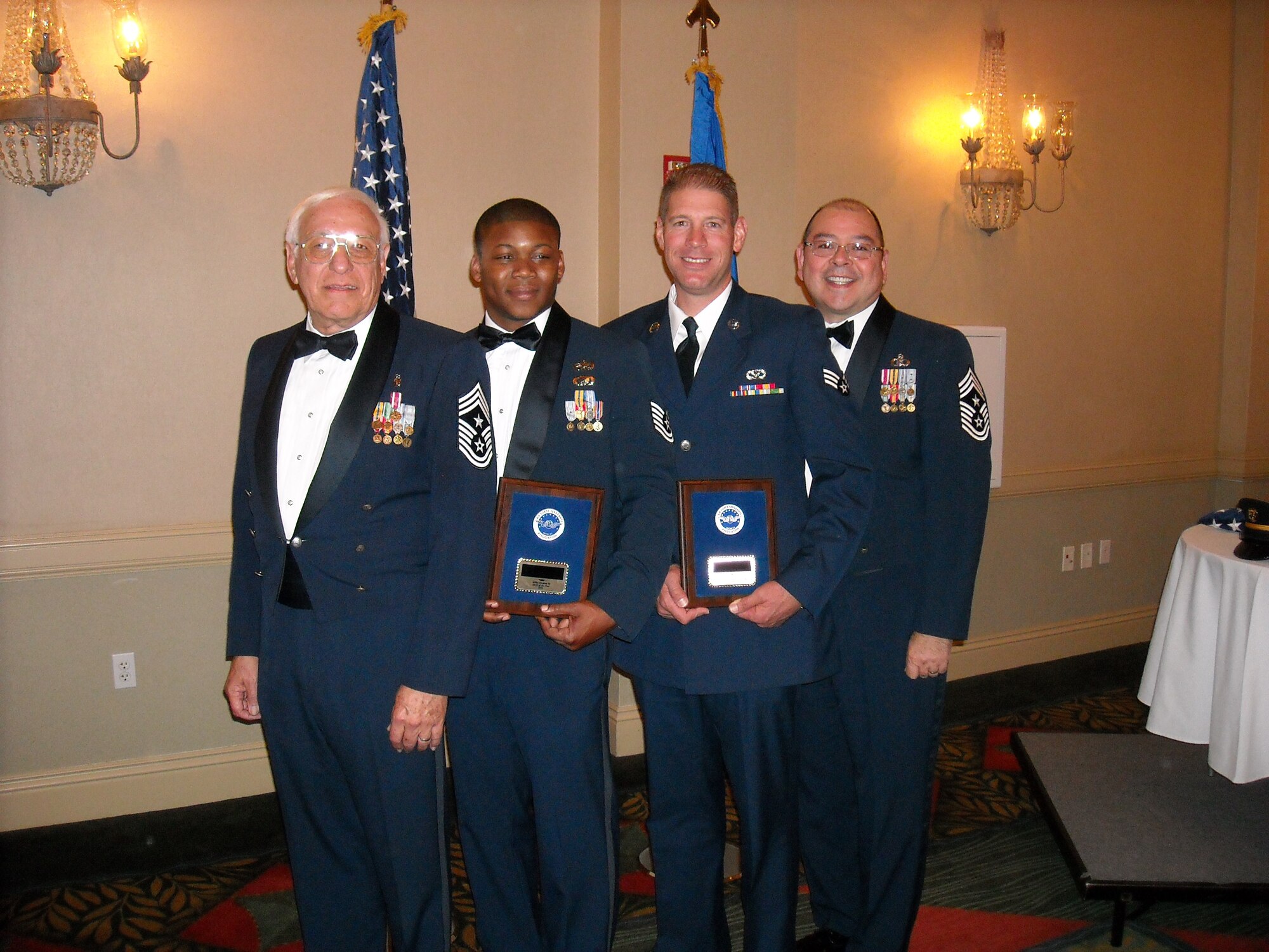 The Air Force Sergeants Association Honors banquet in Fairfield, Calif., was highlighted by an unprecedented win by the 452d Air Mobility Wing nominees. Senior Airman Charles Elliott from the 452d Civil Engineering Squadron garnered the First Term Airman of the Year Award and by Technical Sgt. Allen Puckett from the 452d Aircraft Maintenance Squadron garnered the Junior NCO of the Year Award.
These Airmen will represent Division 13 (California) in the International competition
in August where they will be interviewed by the CMSAF. (Left to right) Chief Master Sgt. Fred Jacobson, the outgoing President of Division 13 AFSA California, Technical Sgt. Allen Puckett, Senior Airman Charles Elliott and Command Chief Master Sgt. Agustin Huerta at the Air Force Sergeants Association Honors Banquet. (U.S. Air Force courtesy photo)