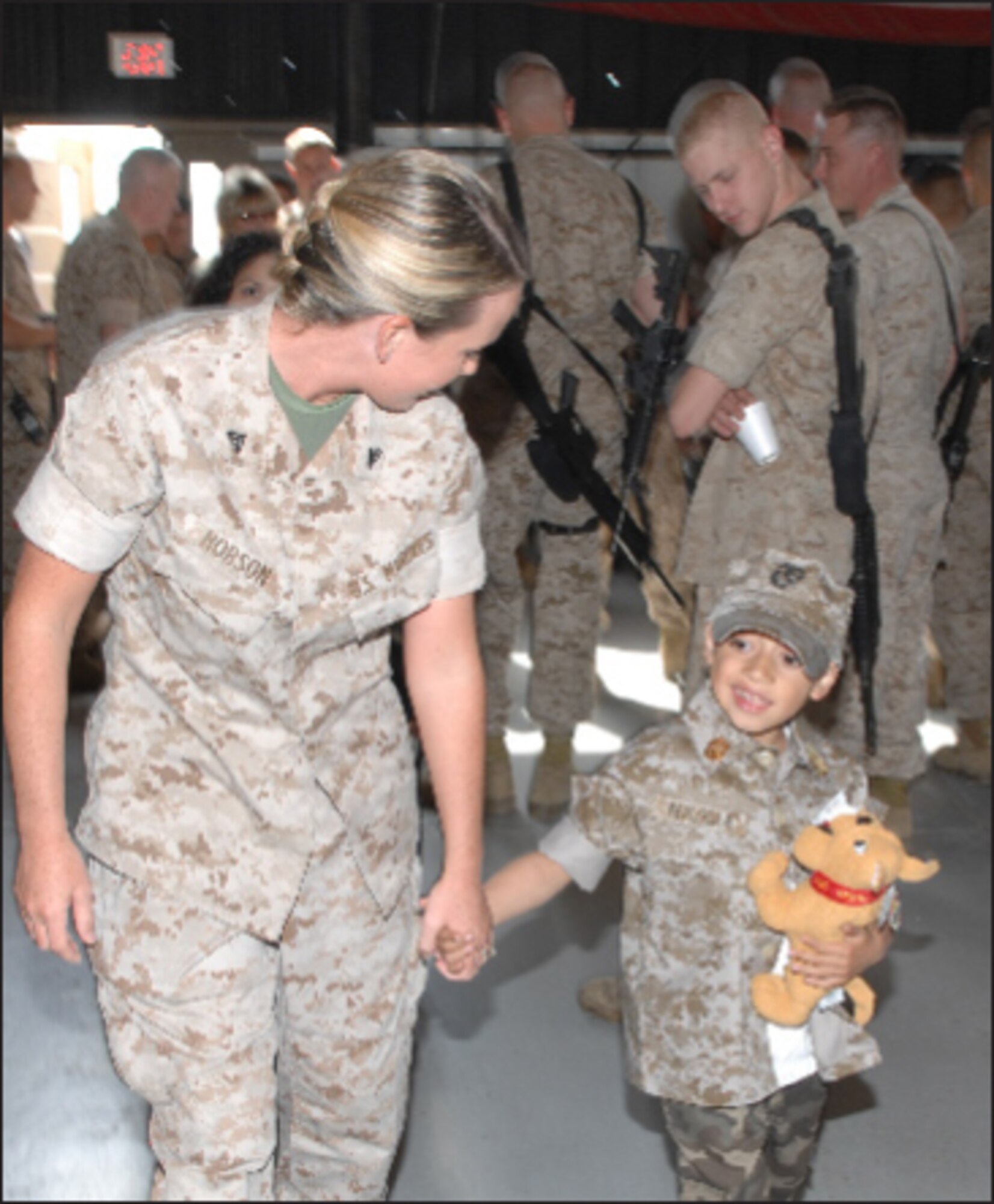 Marines show Andrew the ropes of the deployment hangar while they wait for transport at March. Moments before, Andrew became an honorary Sergeant Major in the Marine Corps, complete with a customized uniform to fit him. (U.S. photos by Staff Sgt. Angel Gallardo)