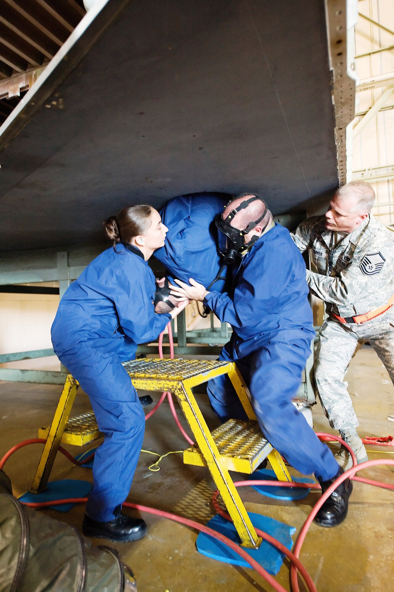 512th Maintenance Squadron fuel systems members Tech. Sgt. Paul Spencer, in the mask, Master Sgt. Jody Parker and Senior Airman Sabrina Kibler assist fellow squadron member Staff Sgt. Corey Barnes during an emergency evacuation exercise April 25. The Air Force Reserve Command Inspector General team evaluated maintenance members? ability to rescue personnel trapped in a confined space as one of the requirements for the 512th Airlift Wing?s Unit Compliance Inspection April 23-27.  (U.S. Air Force photo/Jason Minto) 